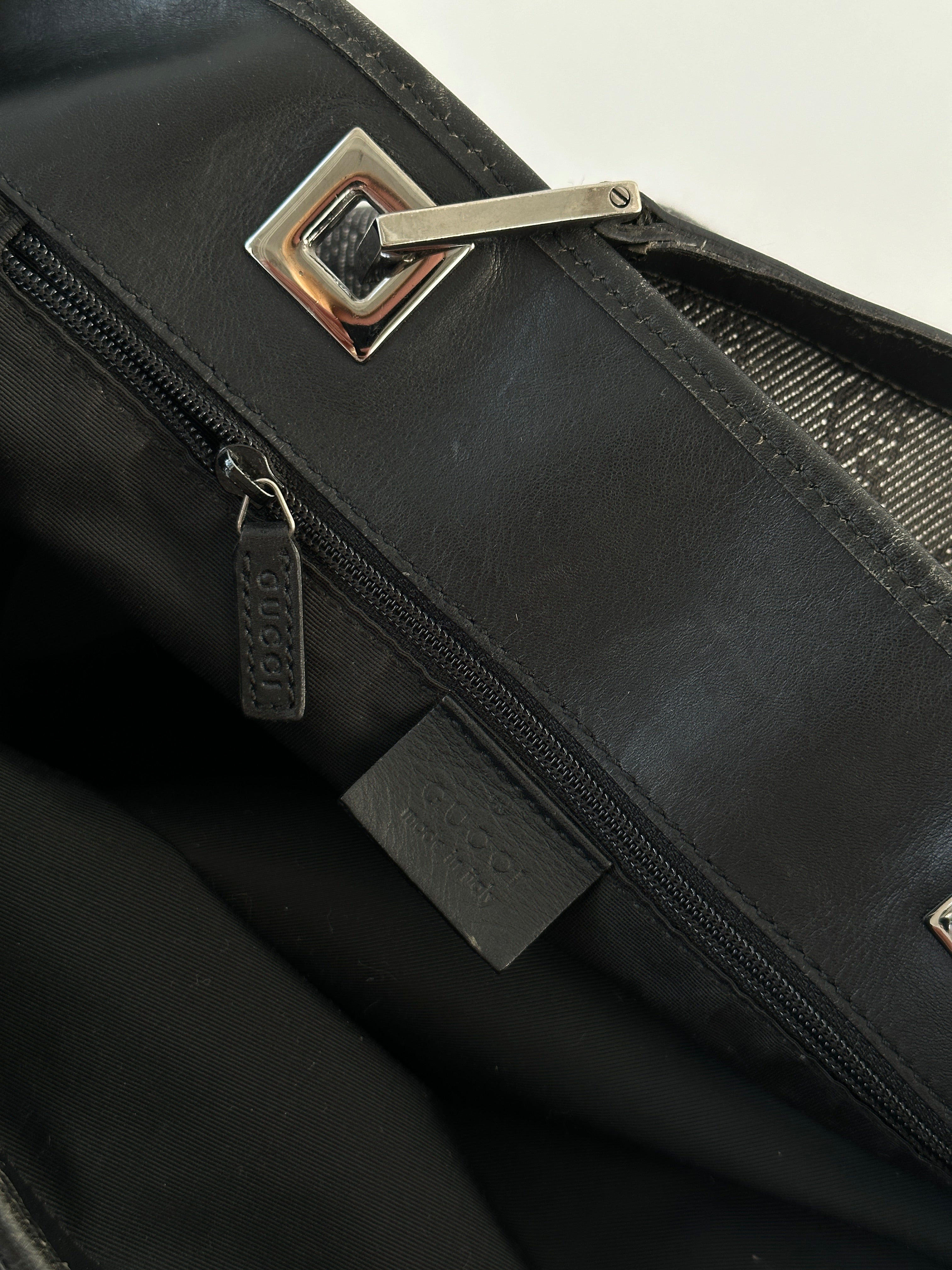 Gucci Monogram GG bucket tote bag with leather accents, featuring the iconic monogram pattern and spacious interior.
