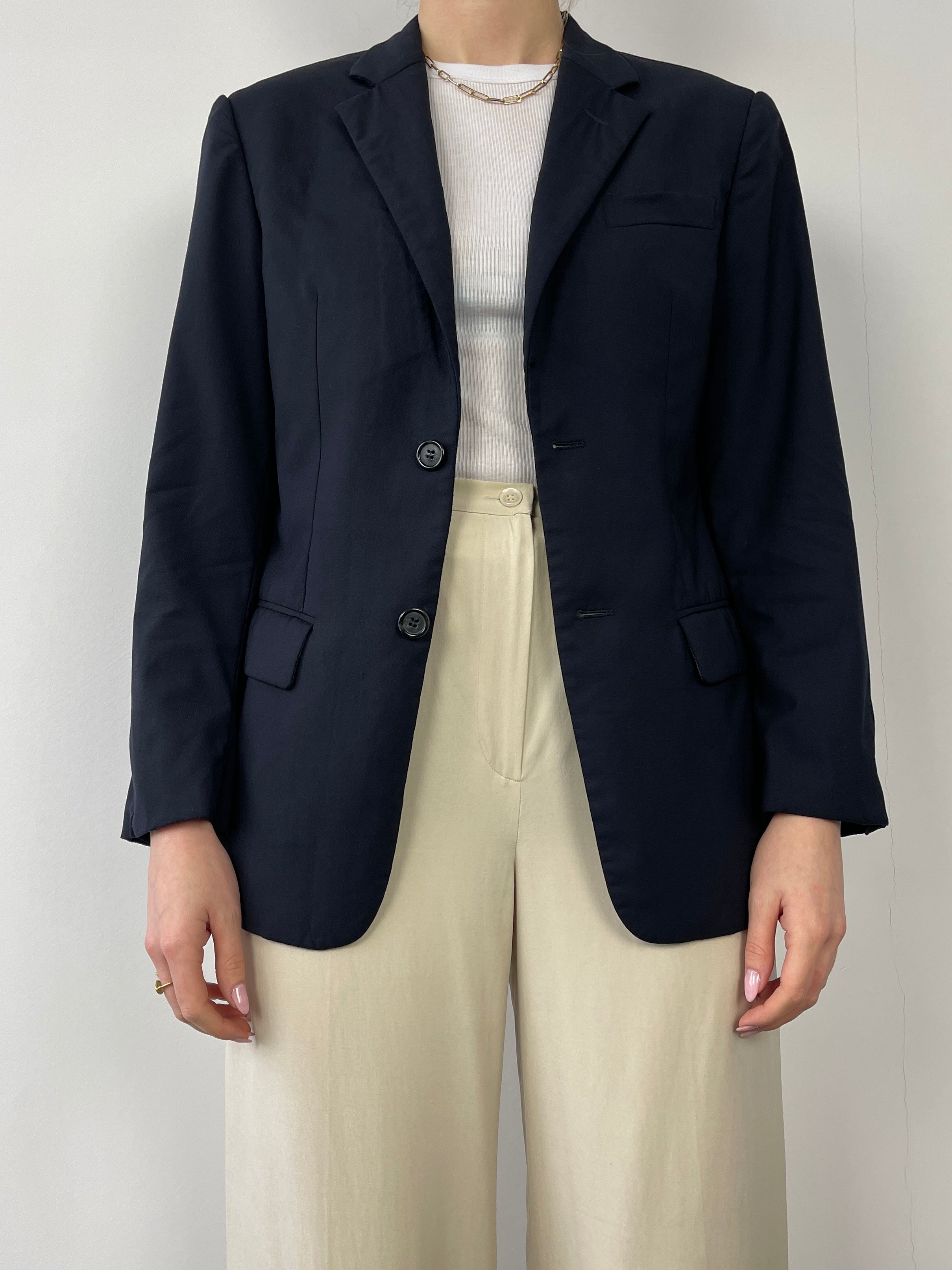 Prada single-breasted tailored blazer in classic design, featuring a fitted silhouette and elegant lapels.