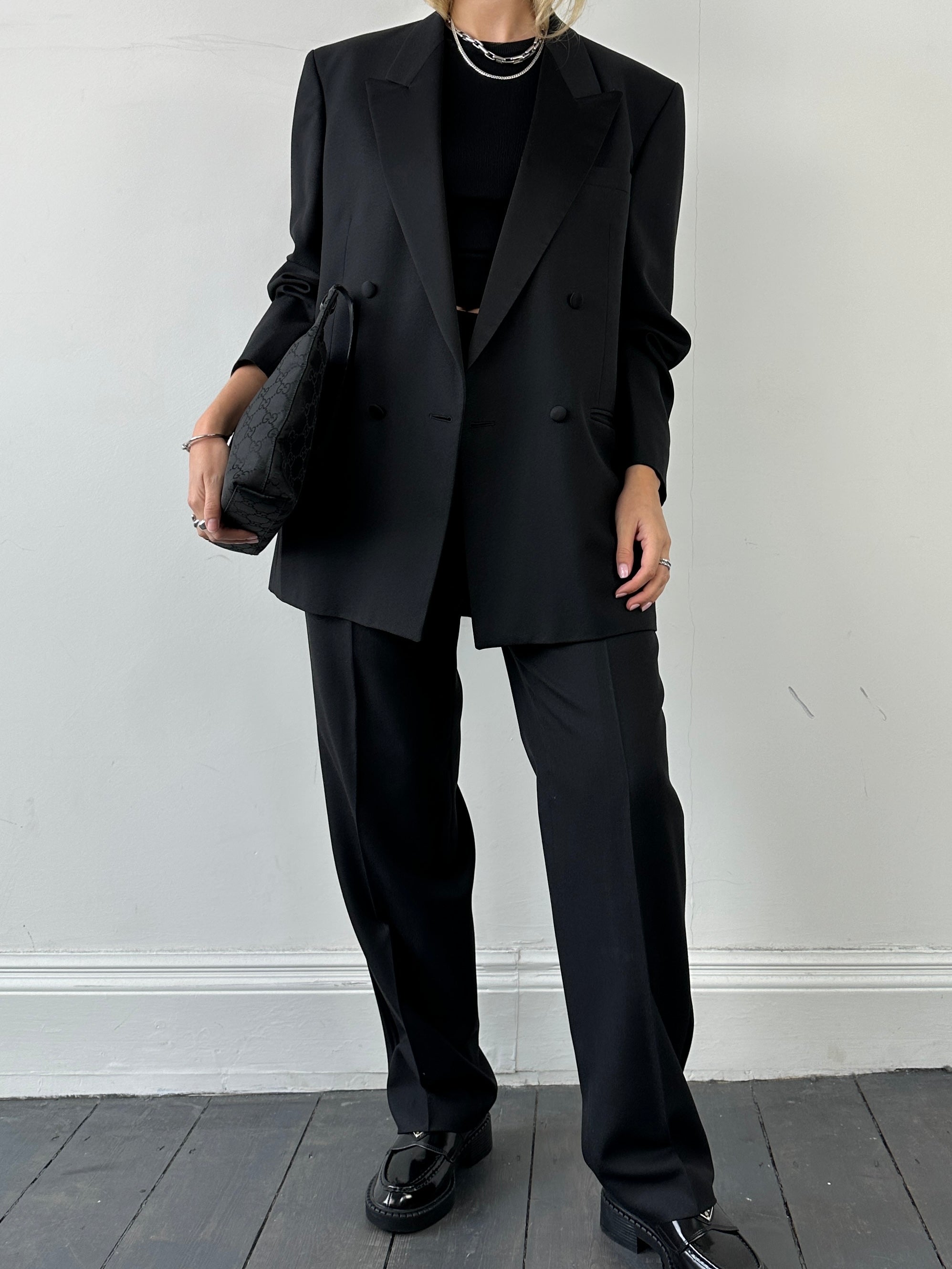 Christian Dior Monsieur tuxedo jumpsuit in double-breasted wool, size 40L/W28, displayed on a hanger.