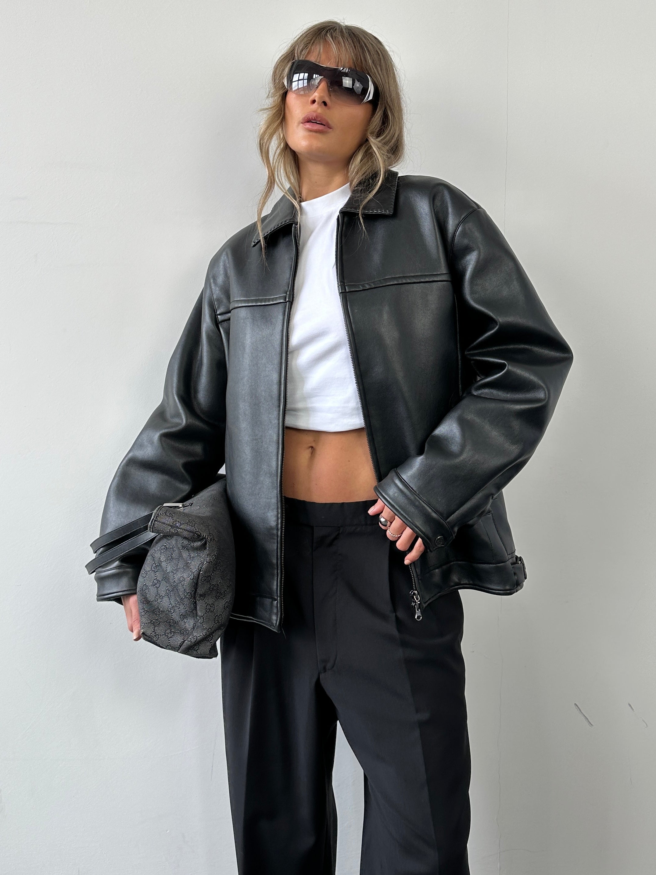 Vintage double zip faux leather jacket in M/L size, featuring a classic design with stylish double zippers and a sleek black finish.