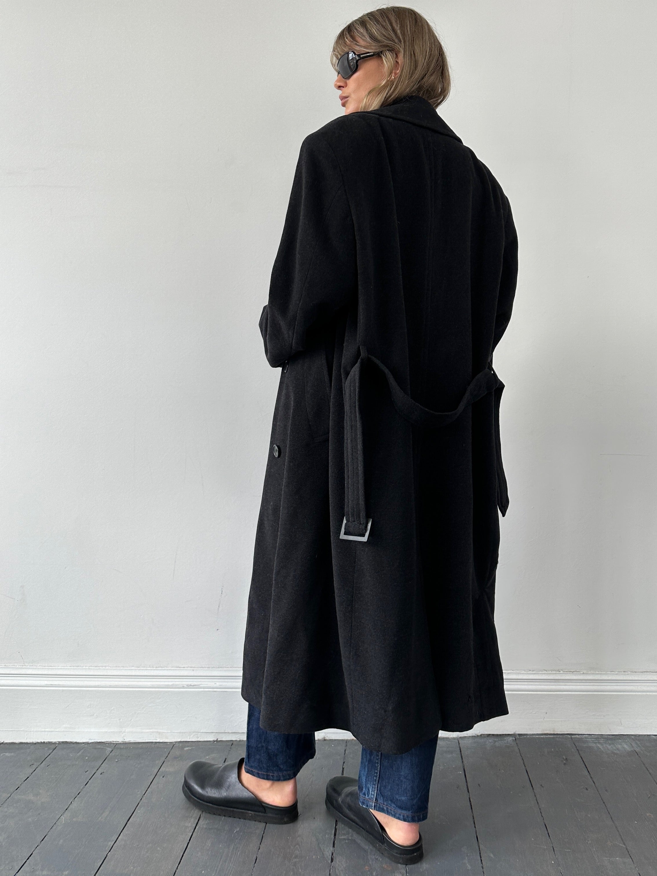 Hugo Boss belted virgin wool coat in size XL, shown hanging with classic tailored design and deep navy color.