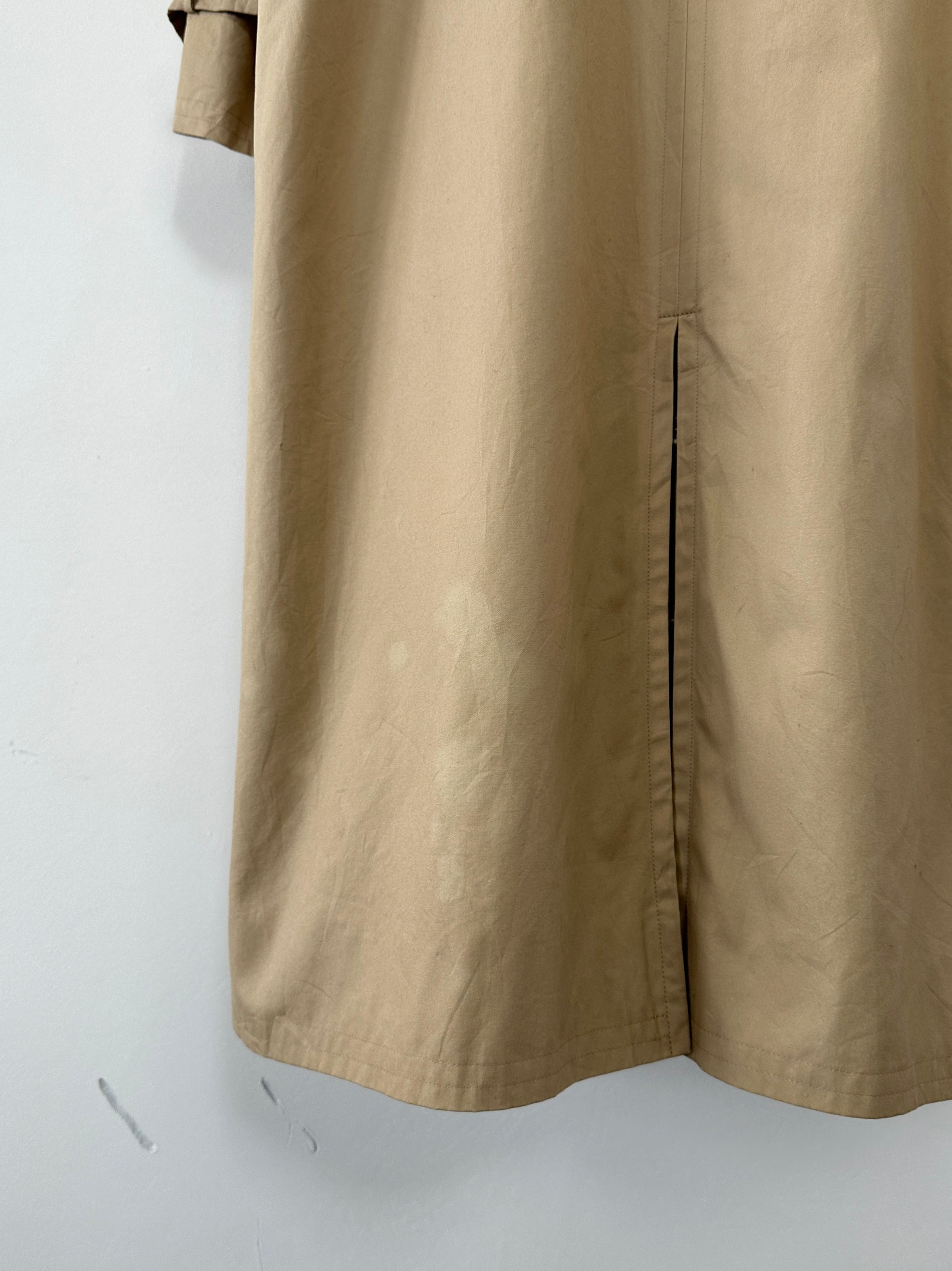 Yves Saint Laurent Paris double-breasted trench coat in size M, beige color, with classic lapel and belt detail on a model.