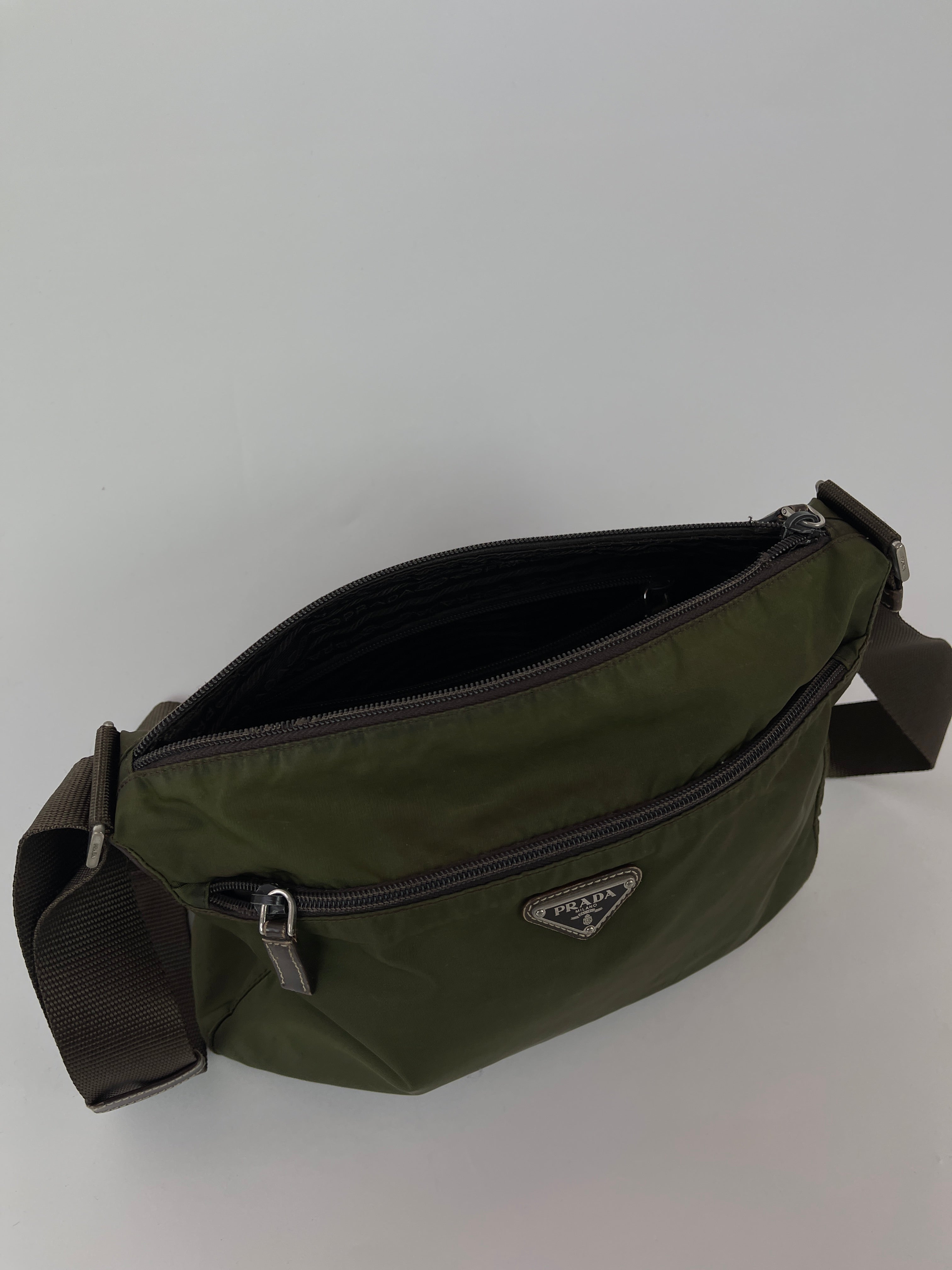 Prada nylon crossbody bag with adjustable strap, featuring sleek design and signature logo on front.