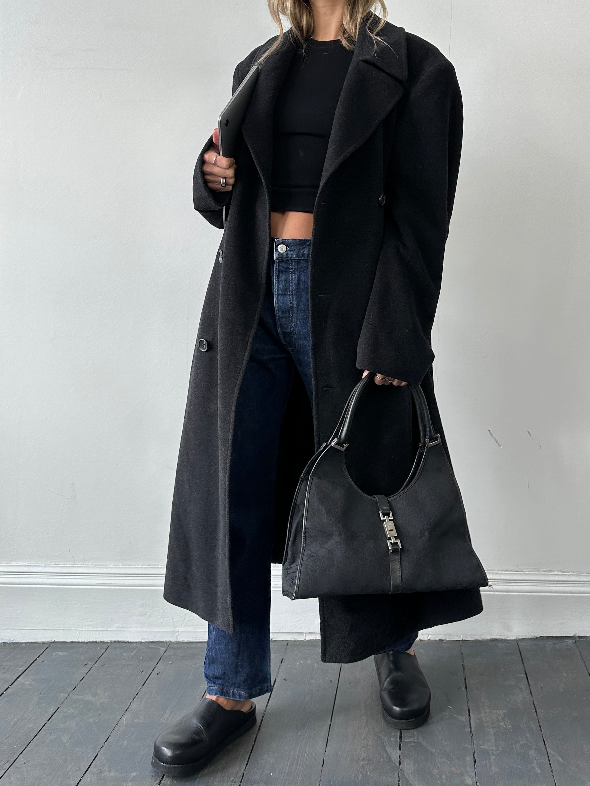 Hugo Boss belted virgin wool coat in XL, shown on a hanger with a classic tailored design and neutral color.