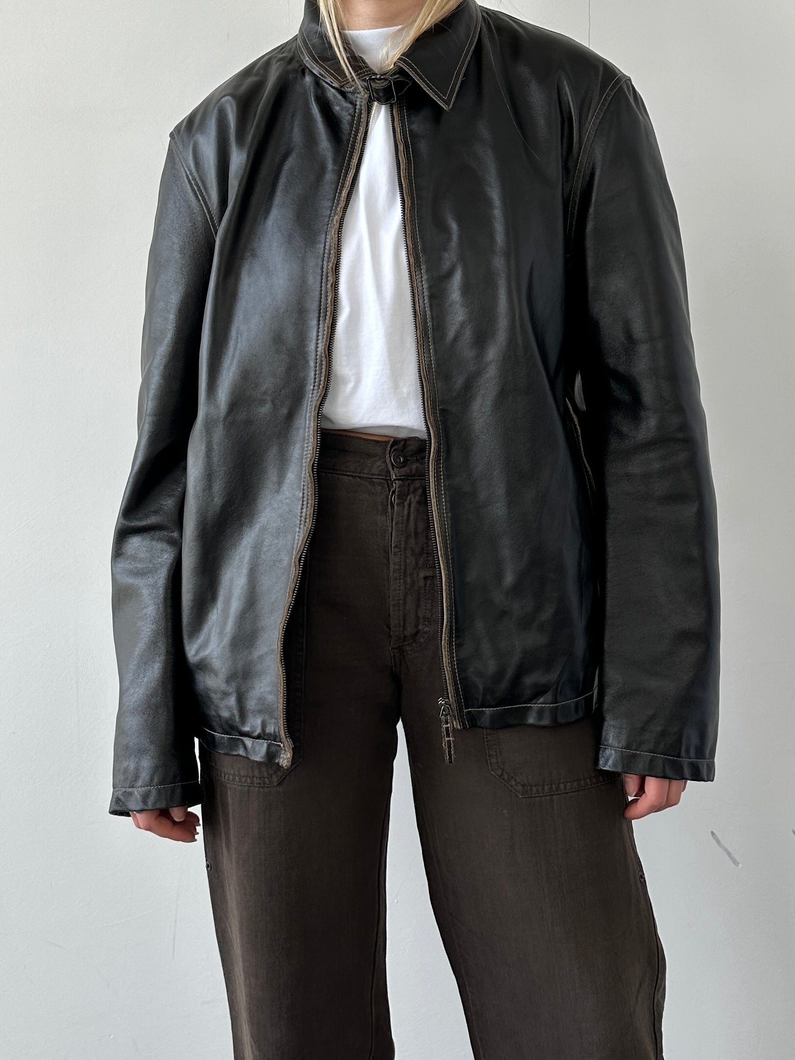 Armani Jeans black leather jacket with contrast stitching and classic design, size large, displayed on a hanger.