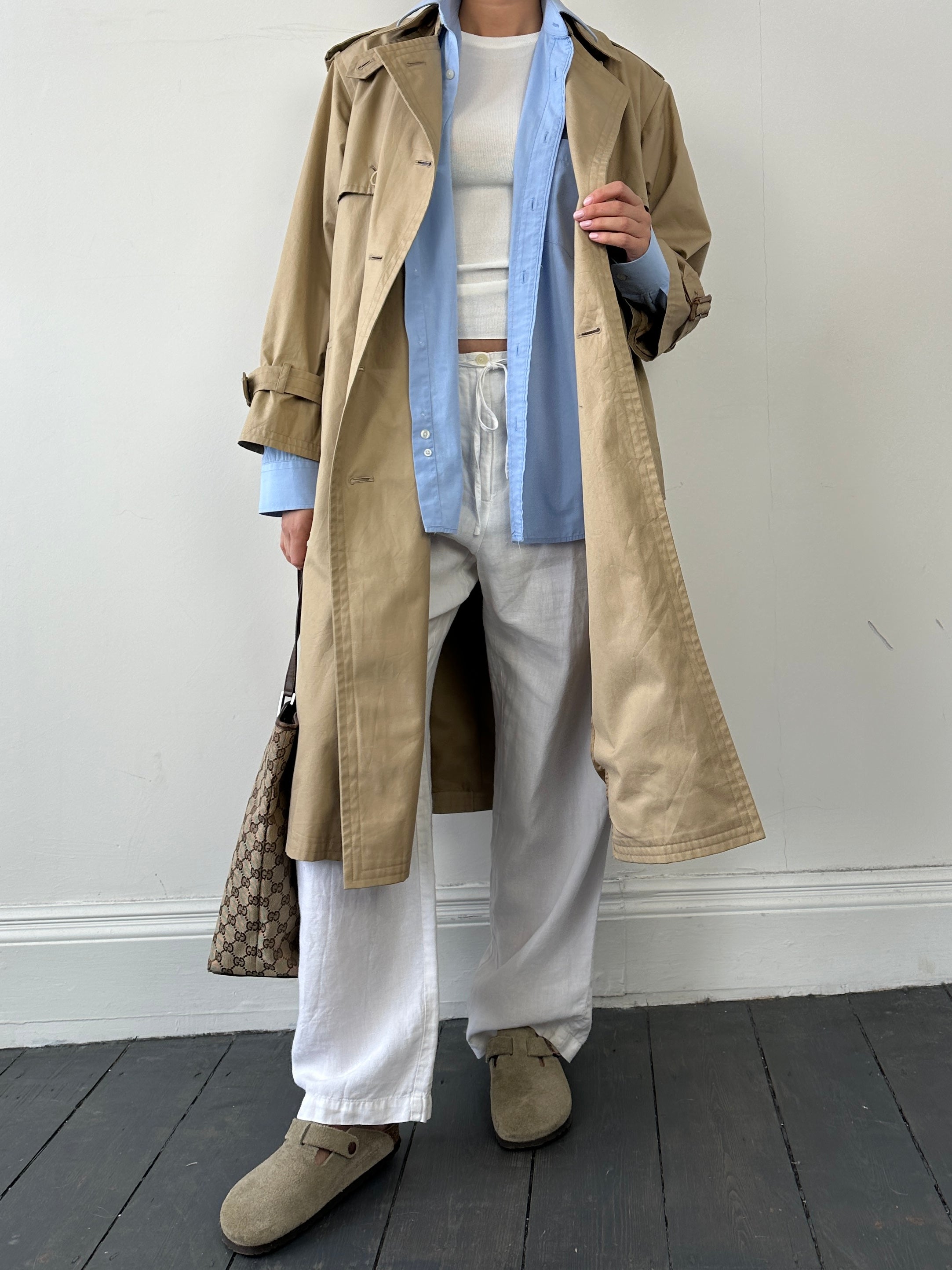 Yves Saint Laurent Paris double-breasted trench coat in size M, featuring classic design with belt and button details.