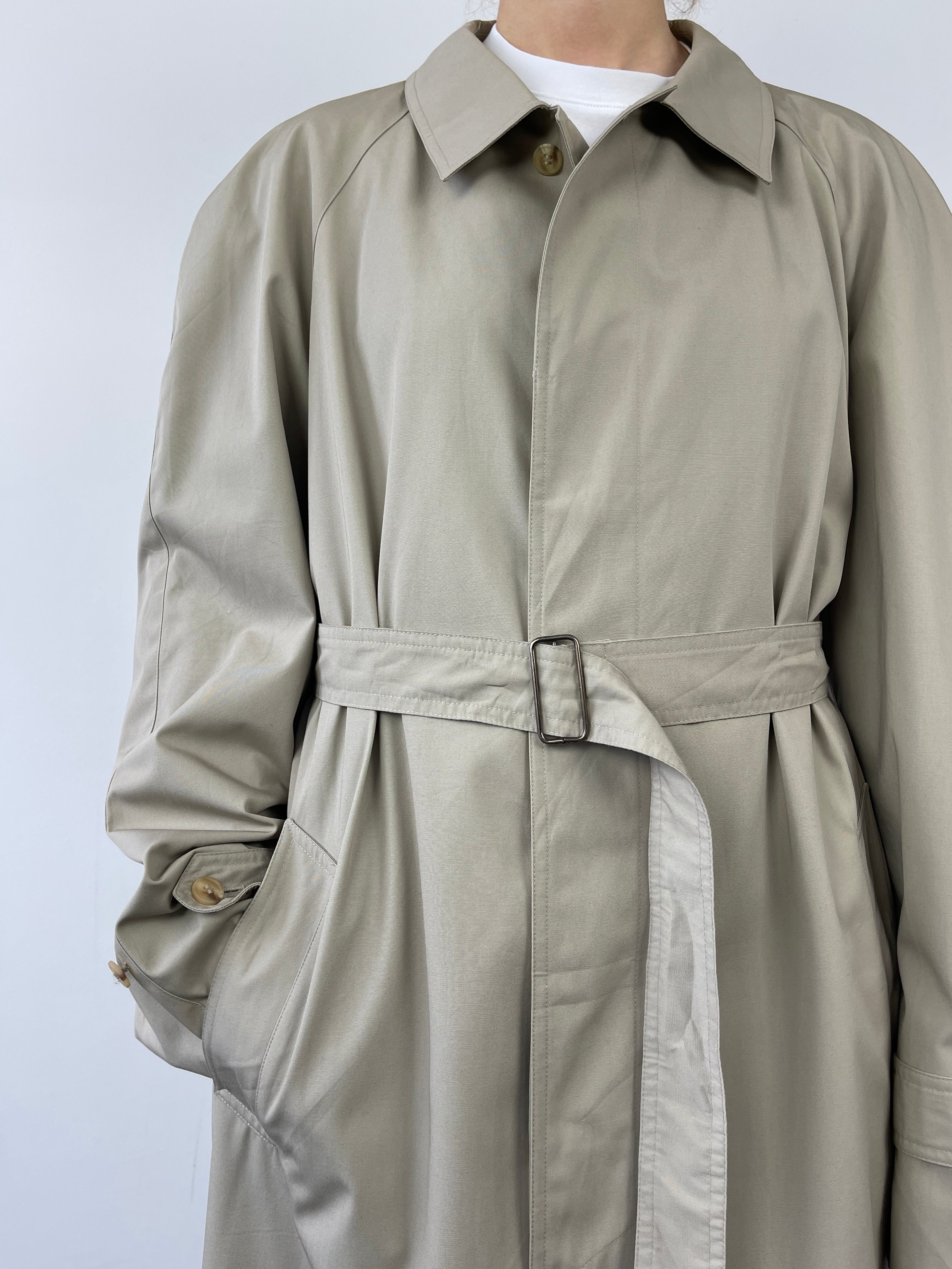 Vintage cotton belted trench coat with classic design, featuring a waist belt and traditional collar, perfect for timeless style.