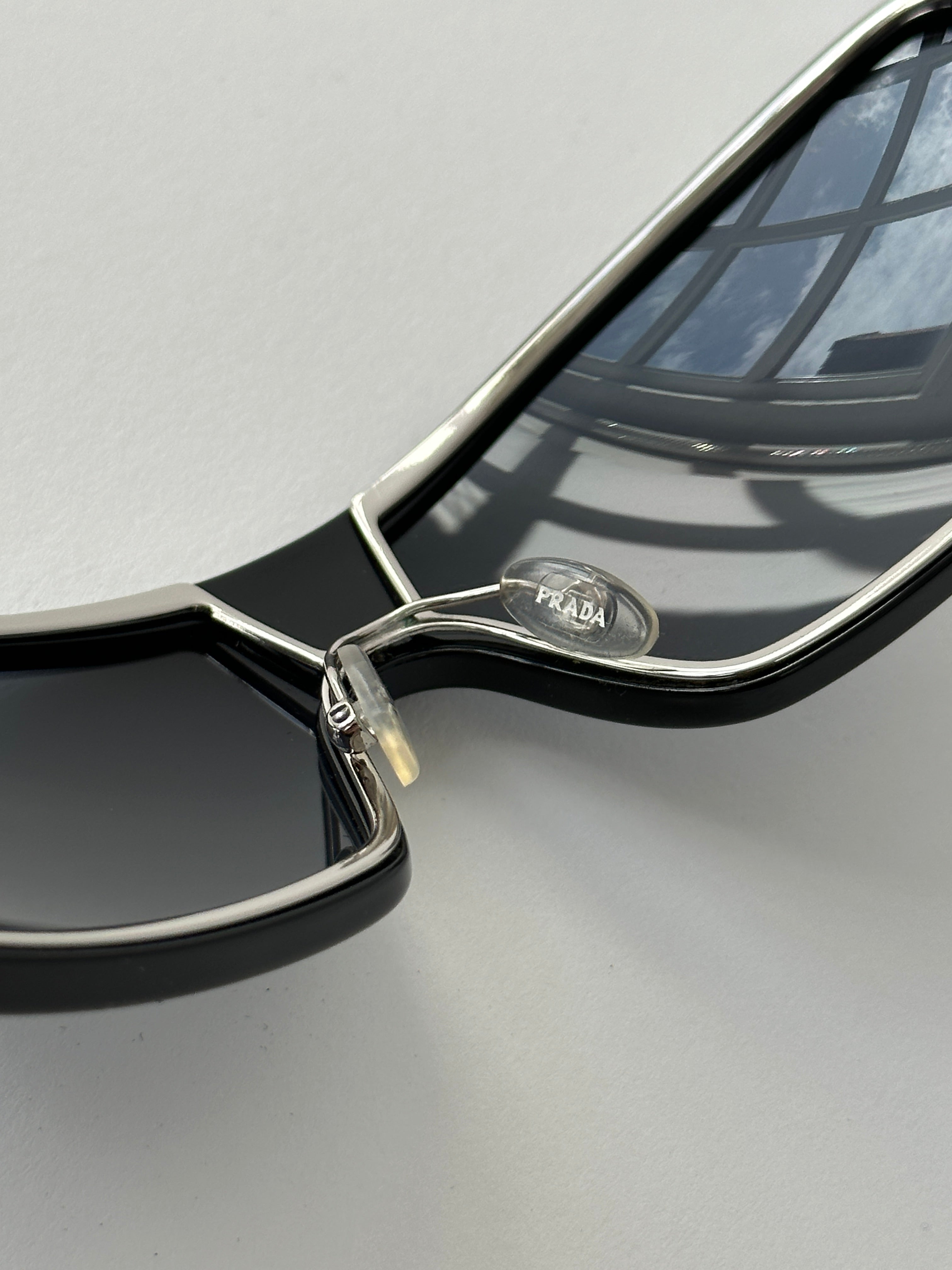 Prada 2000s shield sunglasses with black frames and dark tinted lenses, stylish and bold eyewear for a modern look.