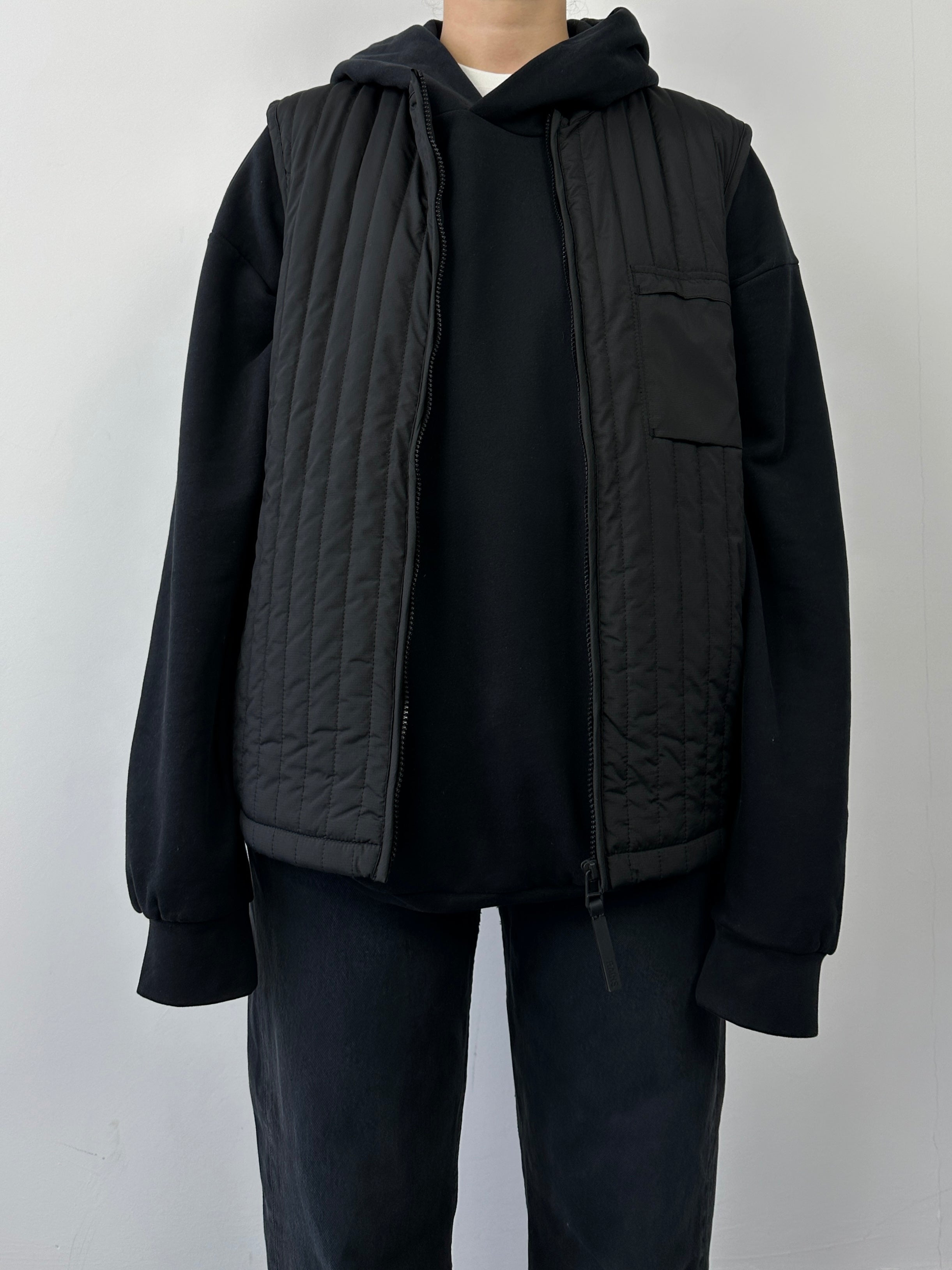 Rains waterproof zip-up liner vest gilet in sleek design, featuring a full front zipper and lightweight, water-resistant fabric.