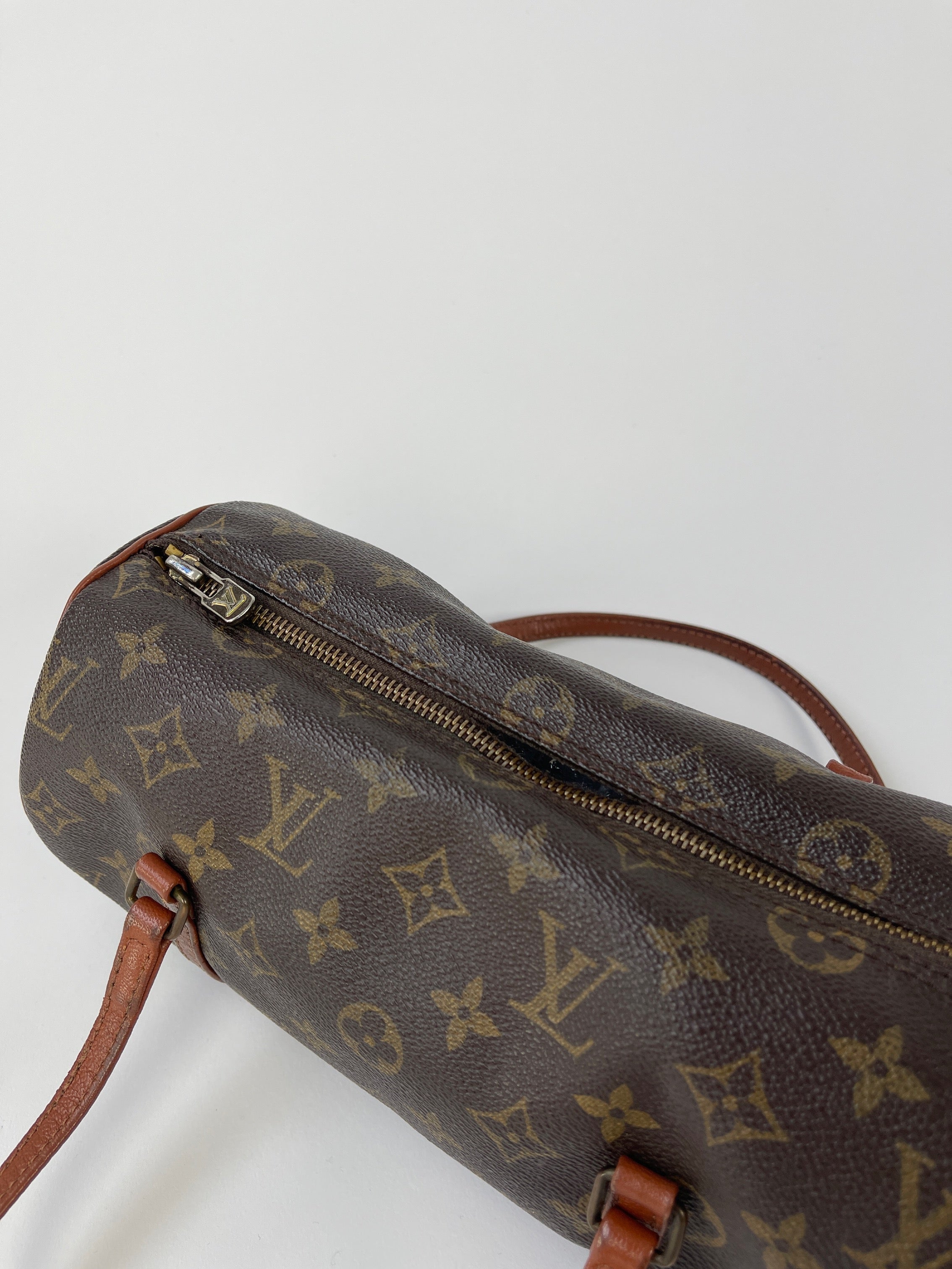 Louis Vuitton 1986 Papillon 26 Monogram handbag with brown leather trim, featuring the iconic LV monogram pattern and top handle.