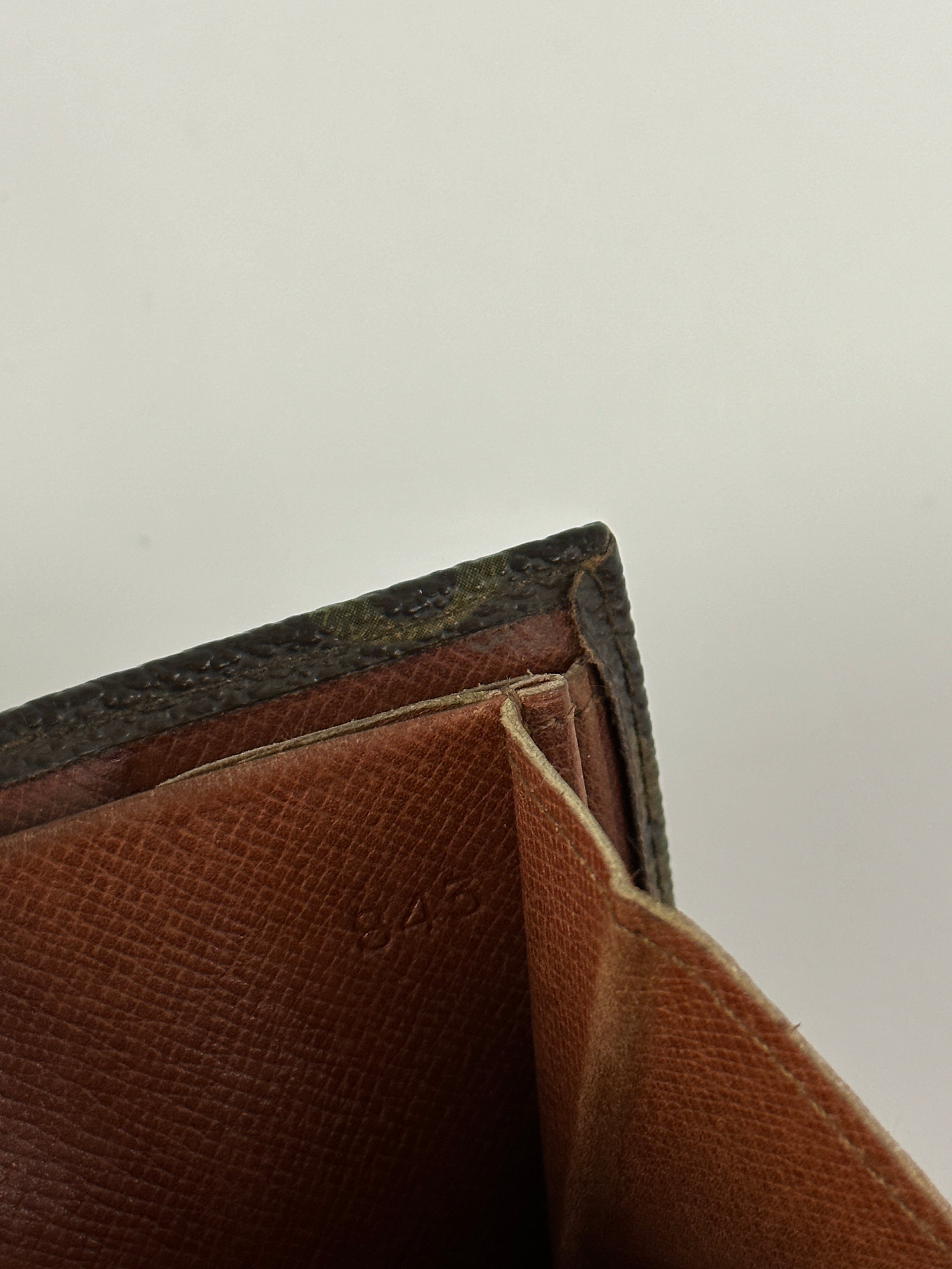Louis Vuitton 1984 Monogram Wallet showing brown leather with signature LV monogram pattern and multiple card slots.