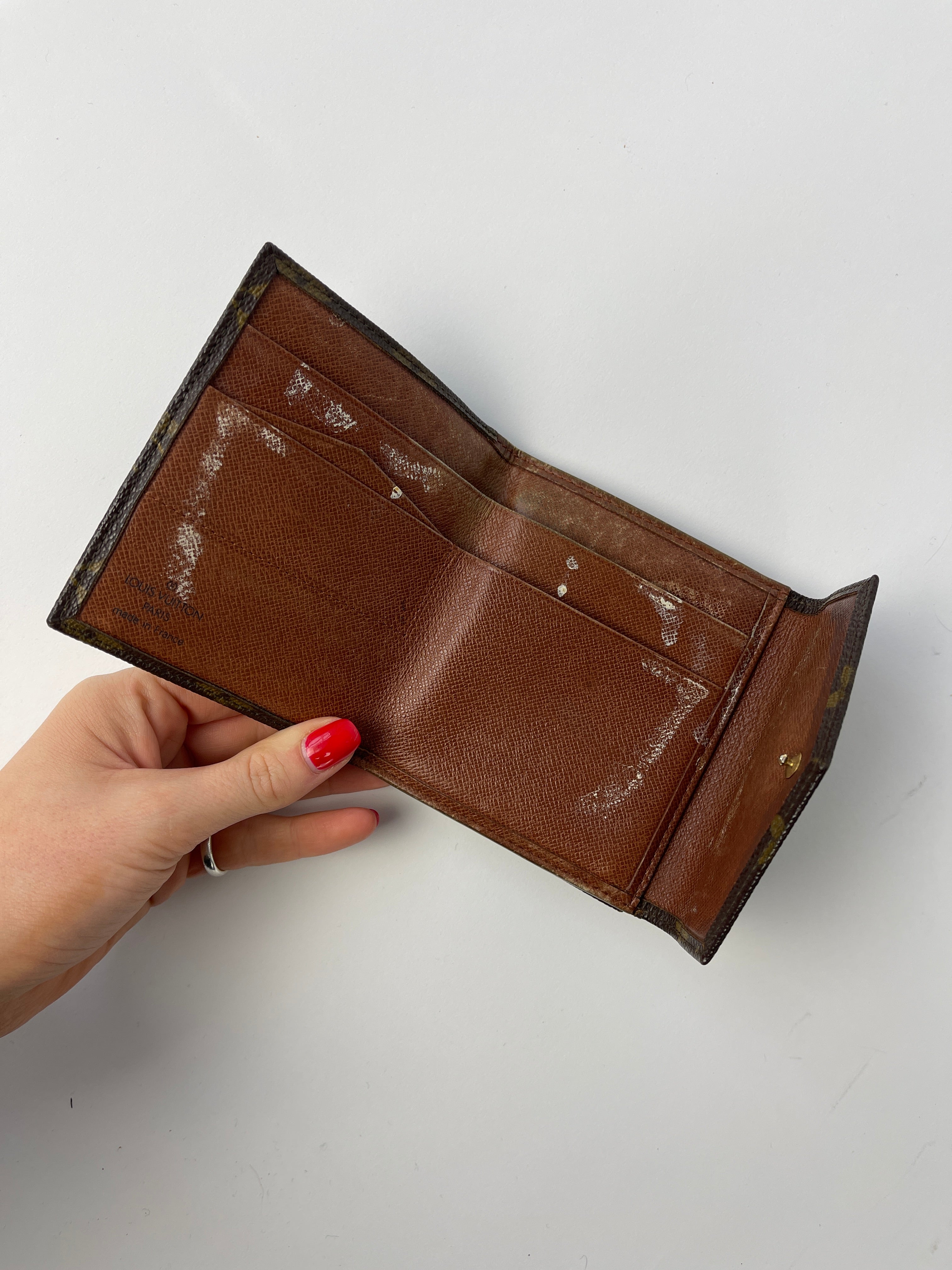 Louis Vuitton 1992 Monogram Wallet showing brown leather exterior with iconic LV monogram pattern and multiple card slots.