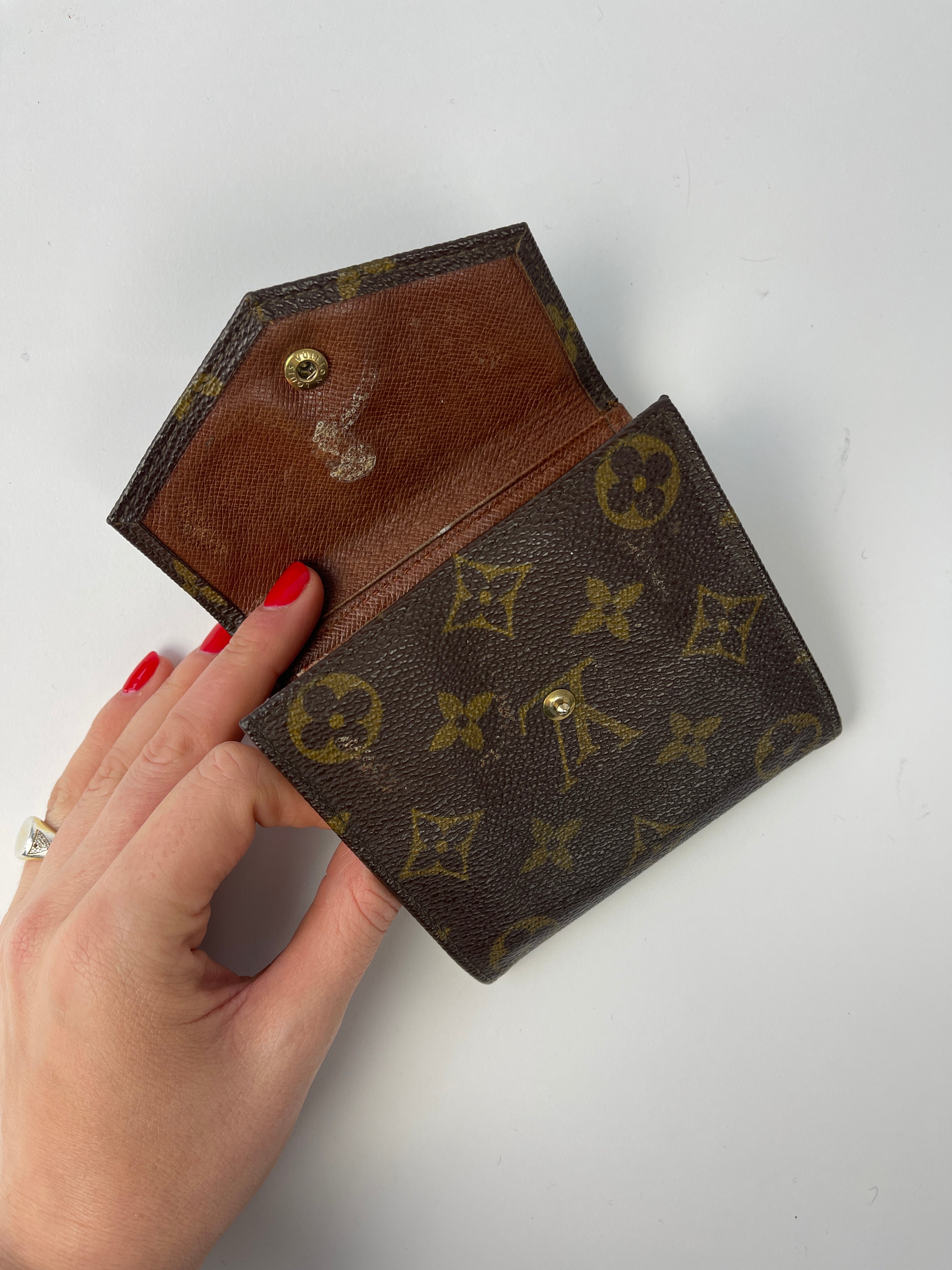 Louis Vuitton 1992 Monogram Wallet showing brown leather exterior and classic LV monogram pattern.