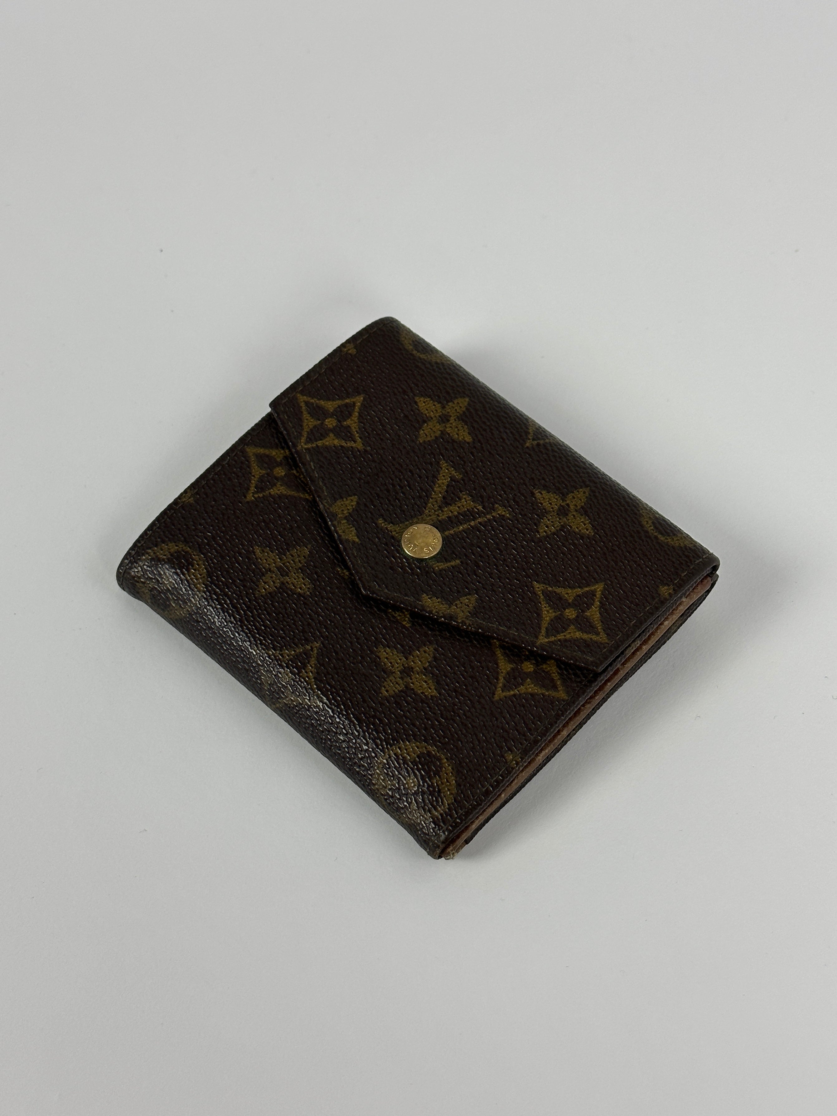Louis Vuitton 1992 Monogram Wallet in brown leather with iconic LV monogram pattern and multiple card slots.