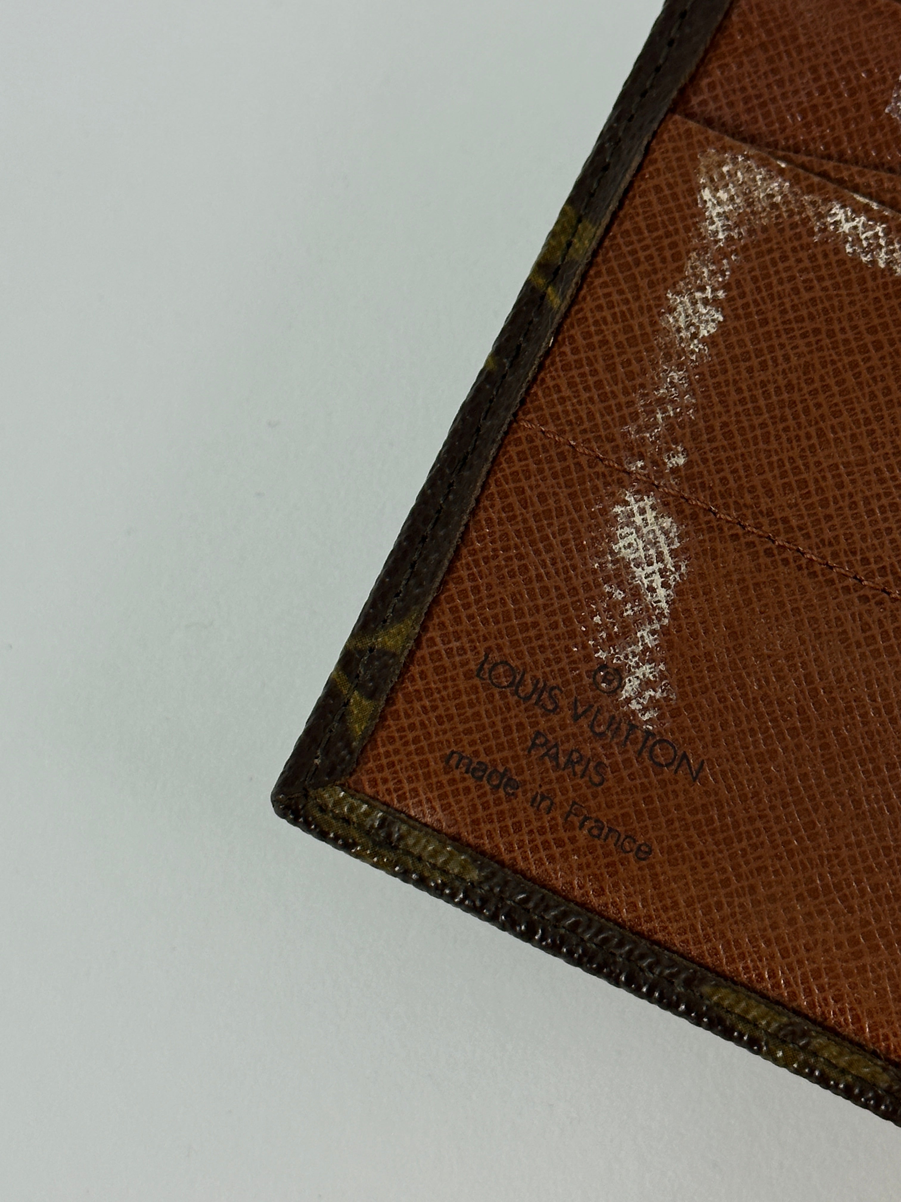 Louis Vuitton 1992 Monogram Wallet in brown leather with monogram pattern, featuring multiple card slots and a zippered coin pocket.