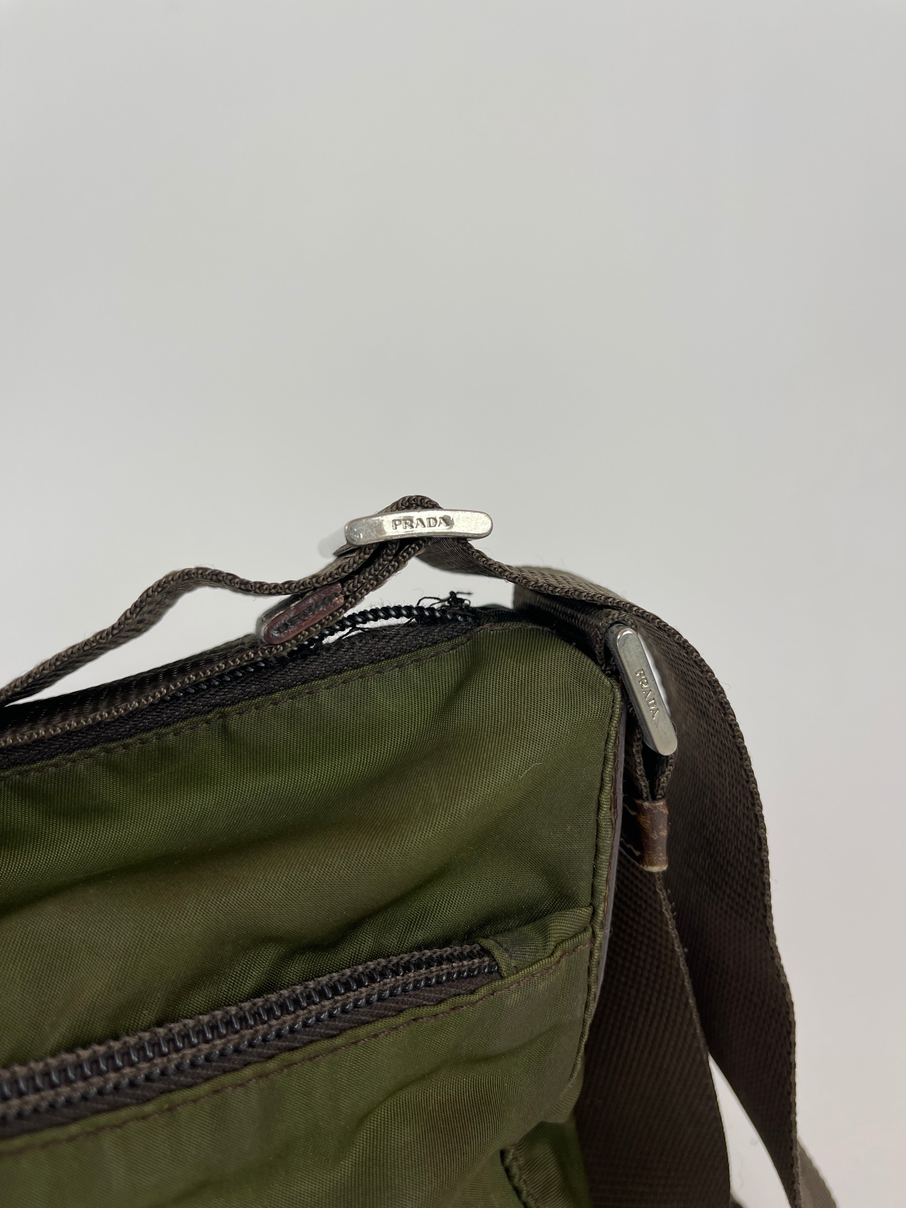 Green Prada nylon crossbody bag with adjustable strap and sleek design, featuring the Prada logo for stylish everyday use.