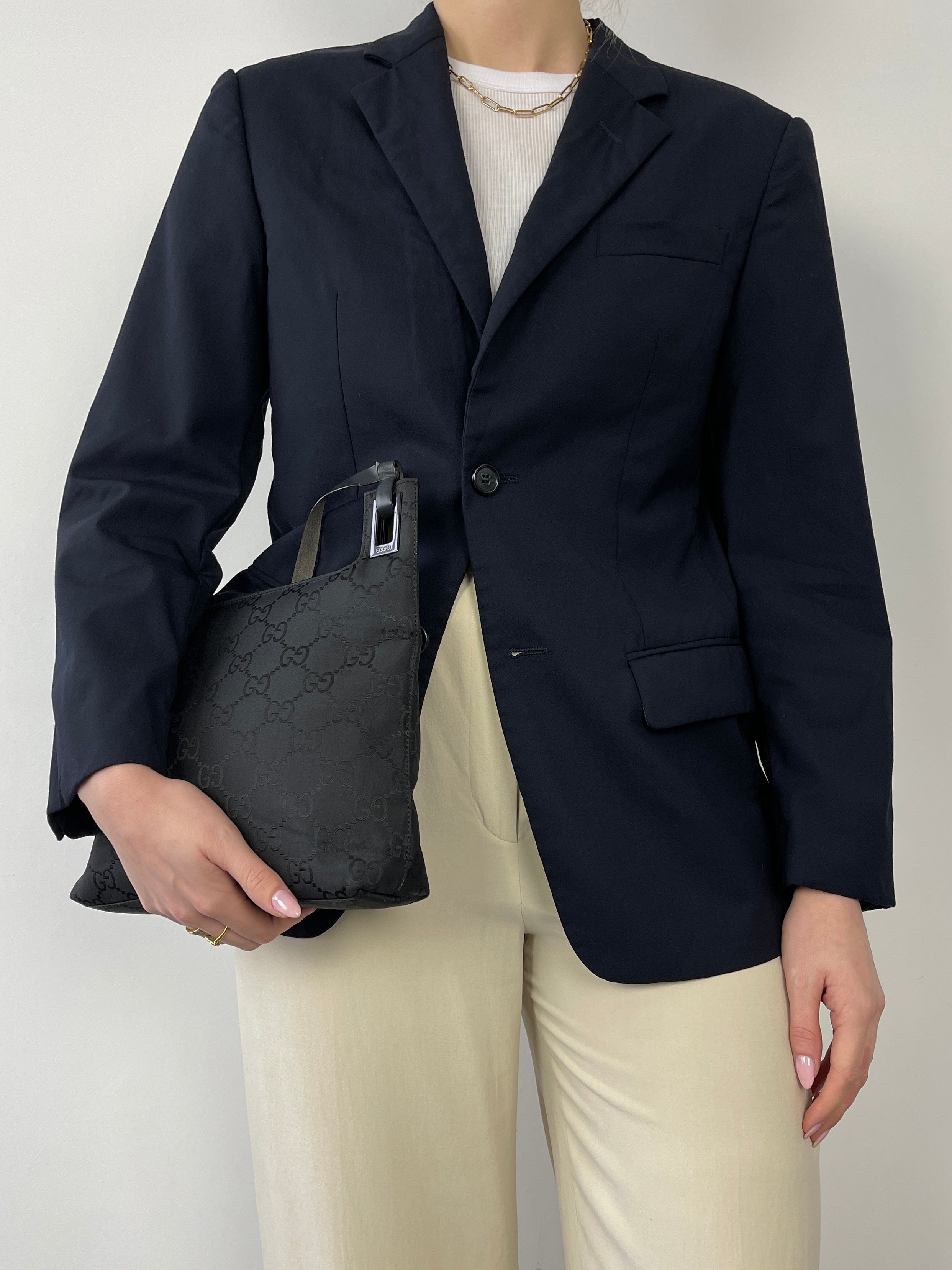 Navy Prada single-breasted tailored blazer with notch lapels and structured fit, displayed on a mannequin.