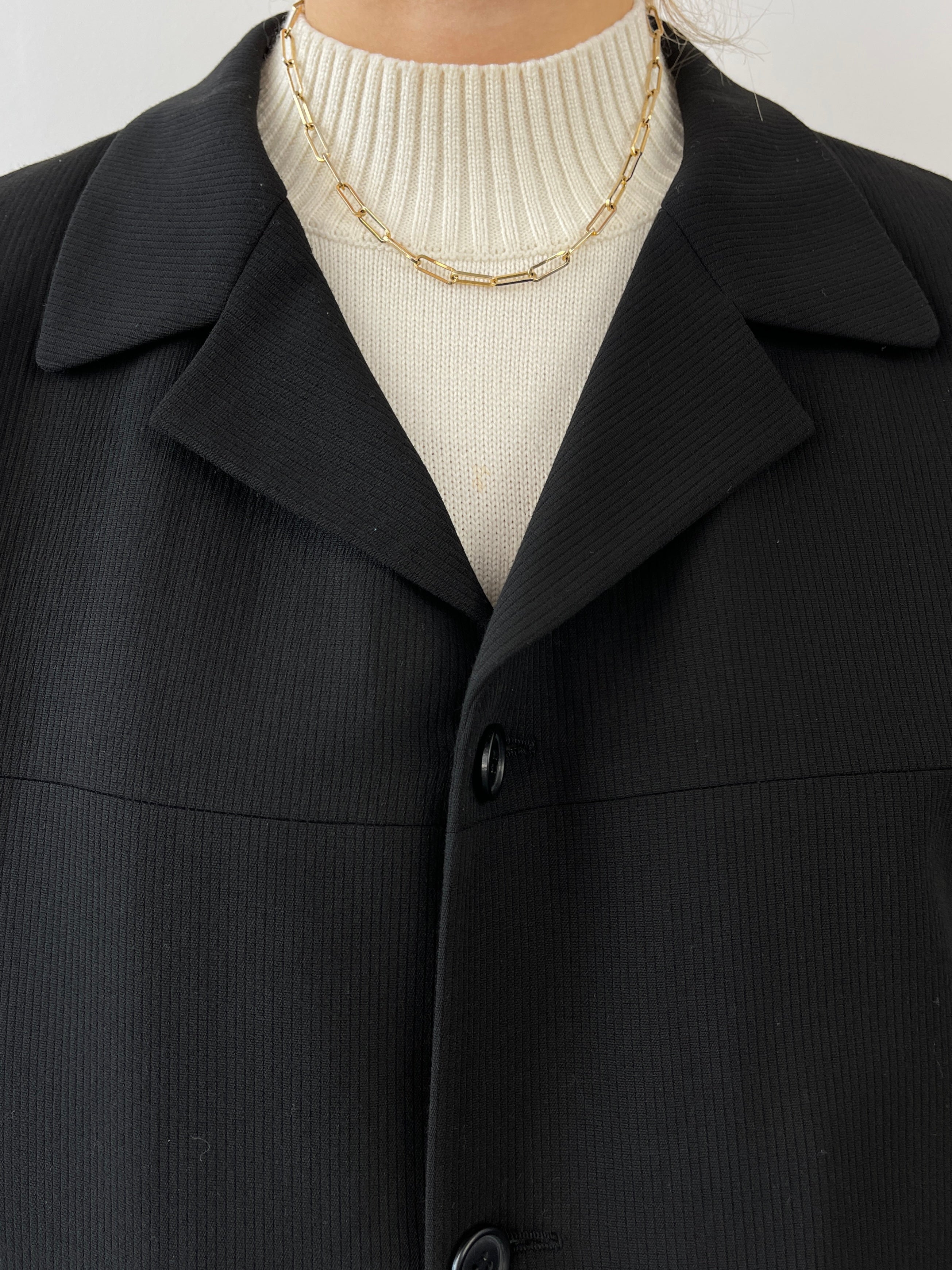 Black vintage relaxed blazer by Vintage, tailored fit with classic lapels and button closure, displayed on a hanger.