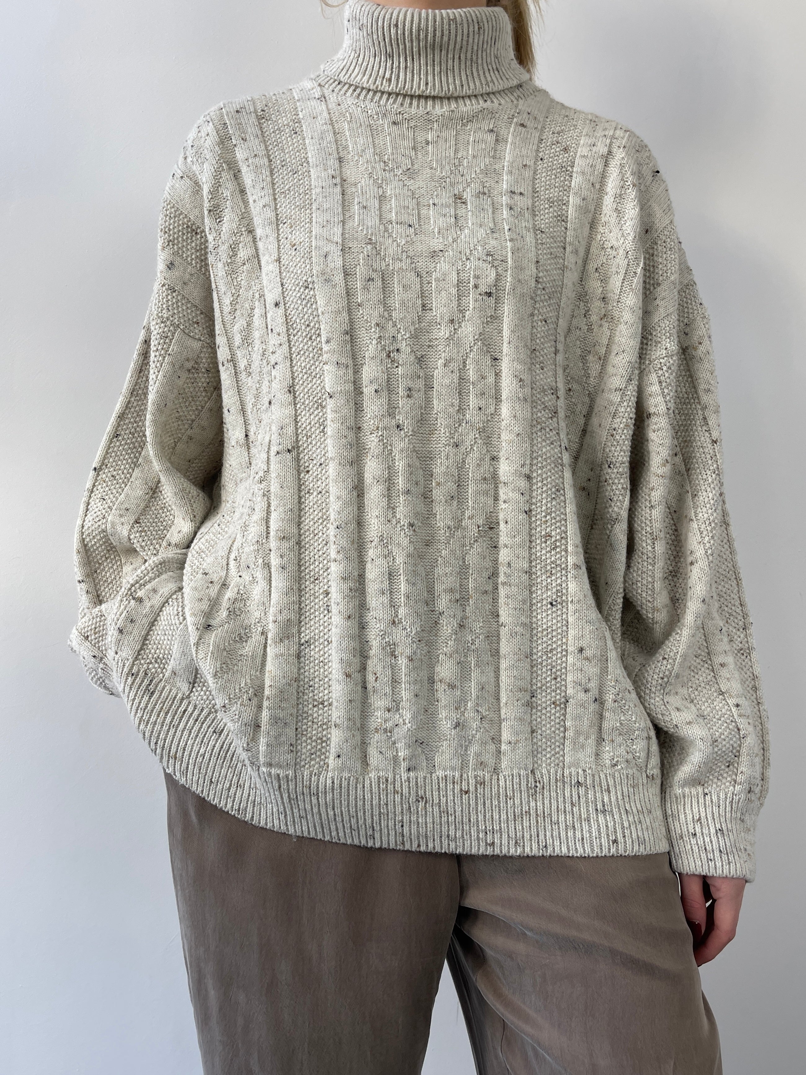 Beige vintage speckle wool roll neck jumper, cozy knit sweater by Vintage, displayed on a plain background.