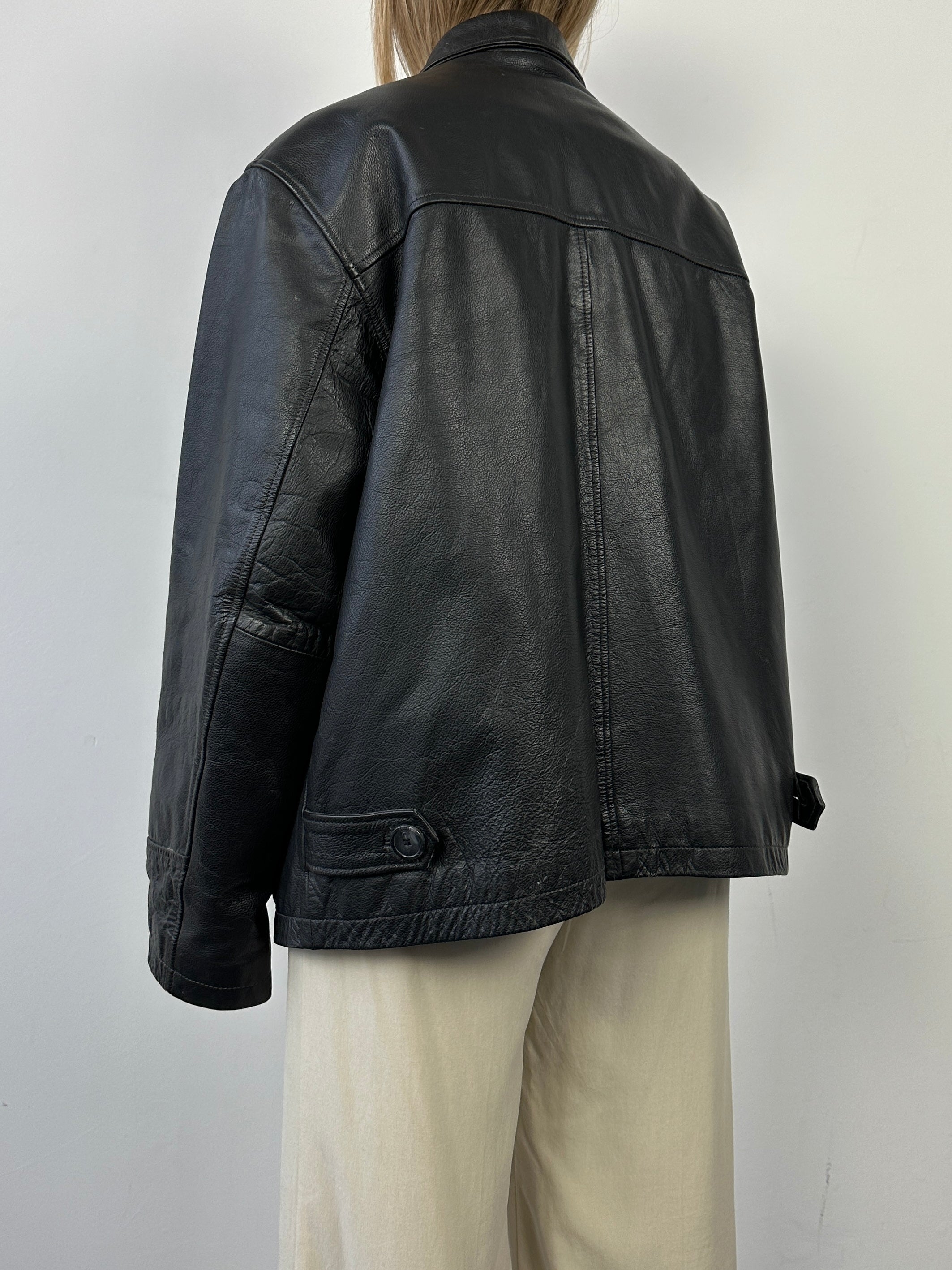 Black vintage boxy leather jacket with classic design and medium fit, featuring a stylish and timeless look.