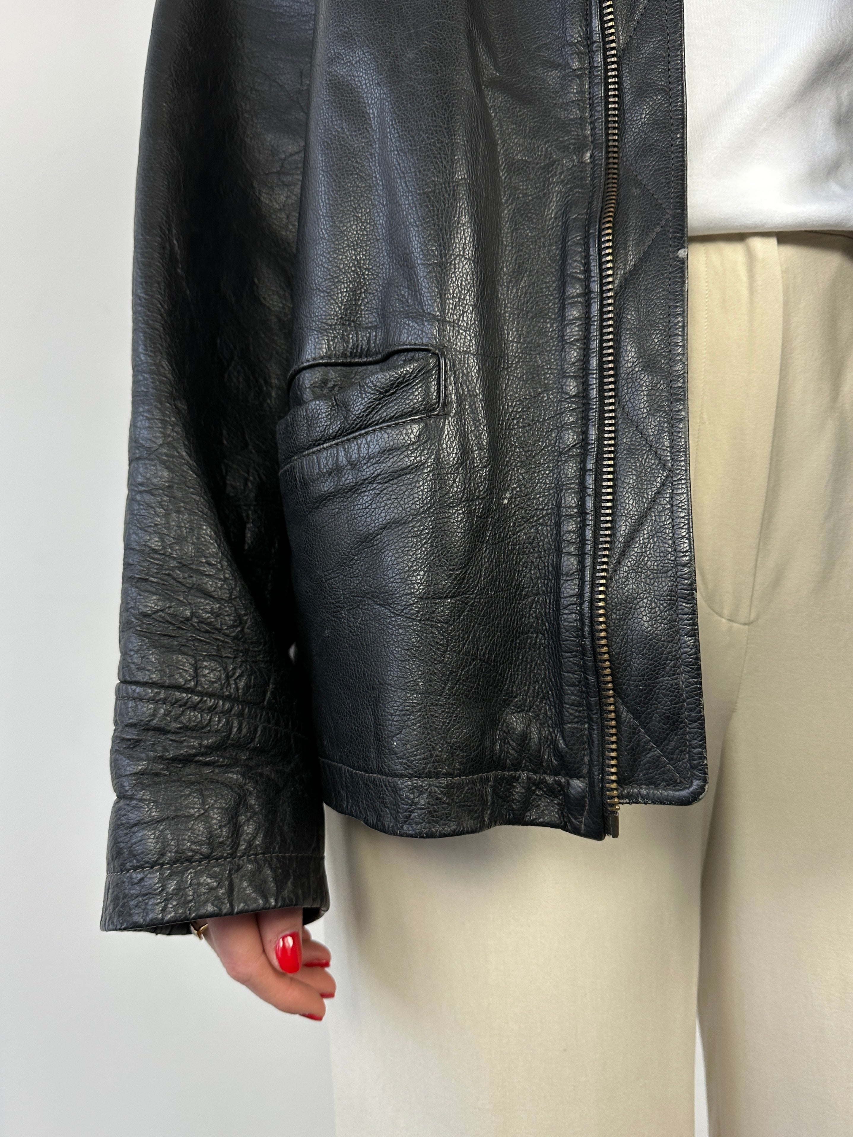 Black vintage boxy leather jacket from Vintage, featuring a classic design and medium size, displayed on a hanger.