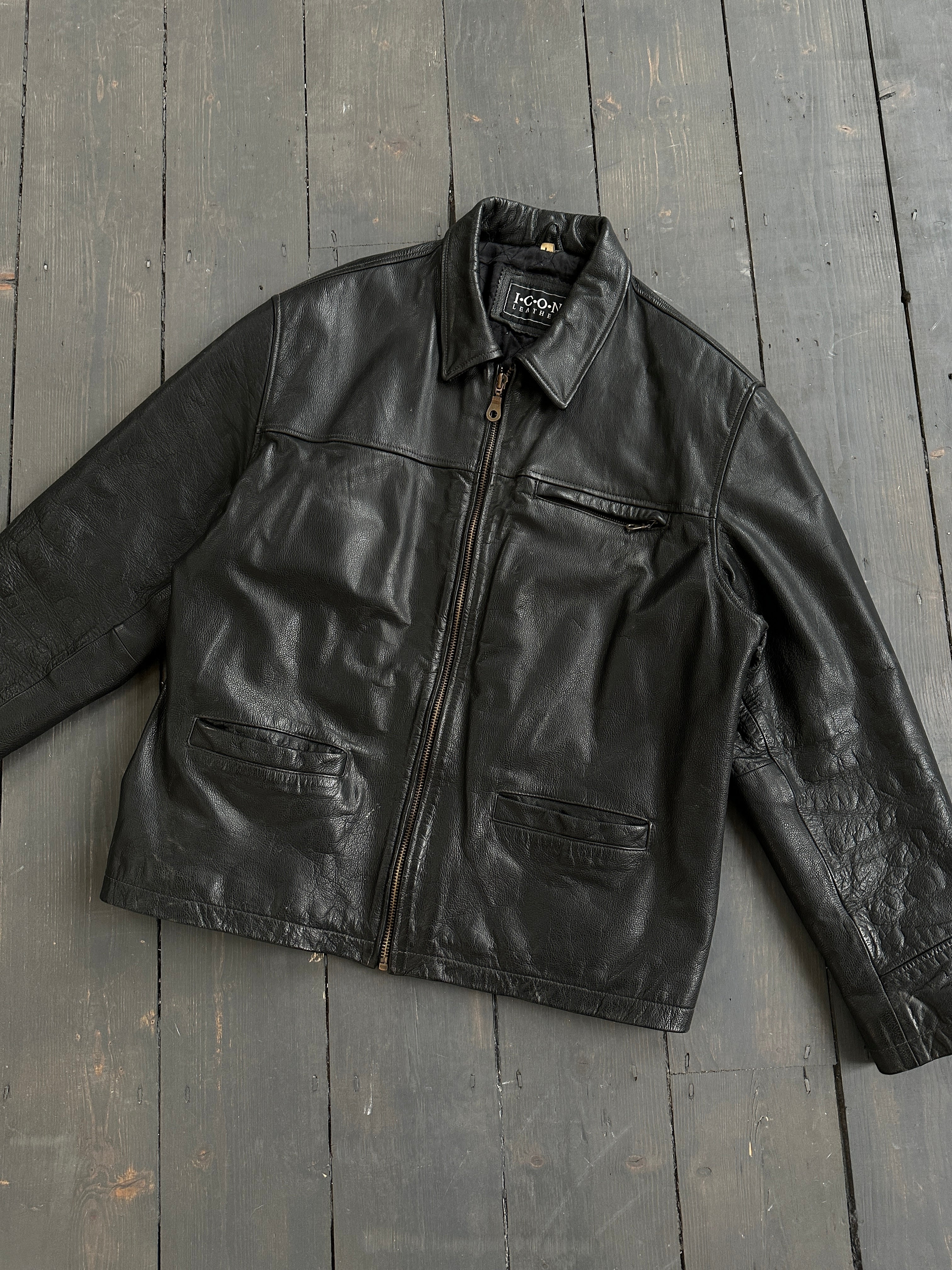Black vintage boxy leather jacket, medium size, stylish and timeless design by Vintage, shown on a model.