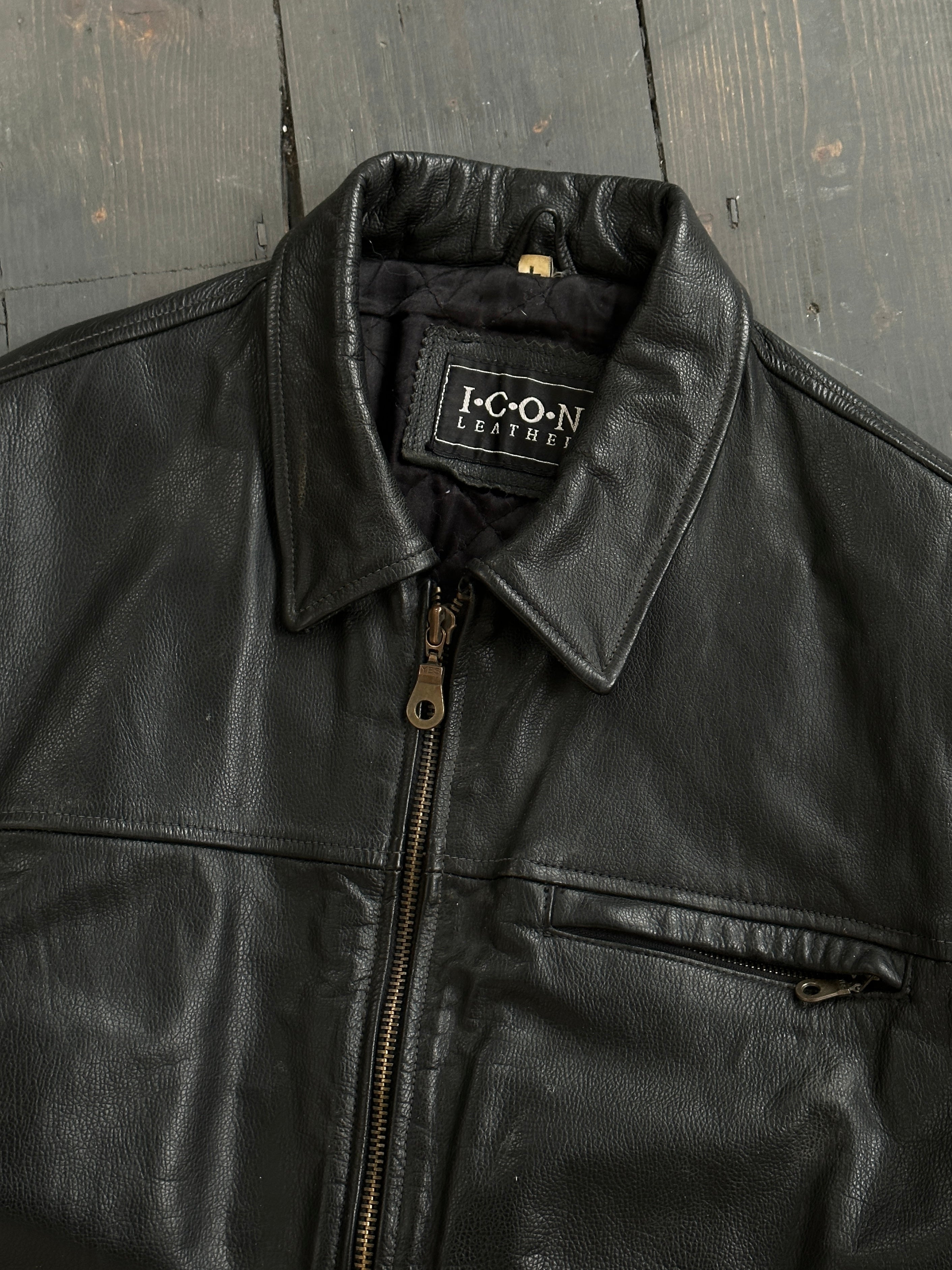Black vintage boxy leather jacket from Vintage, shown on a model with front zipper and classic collar.