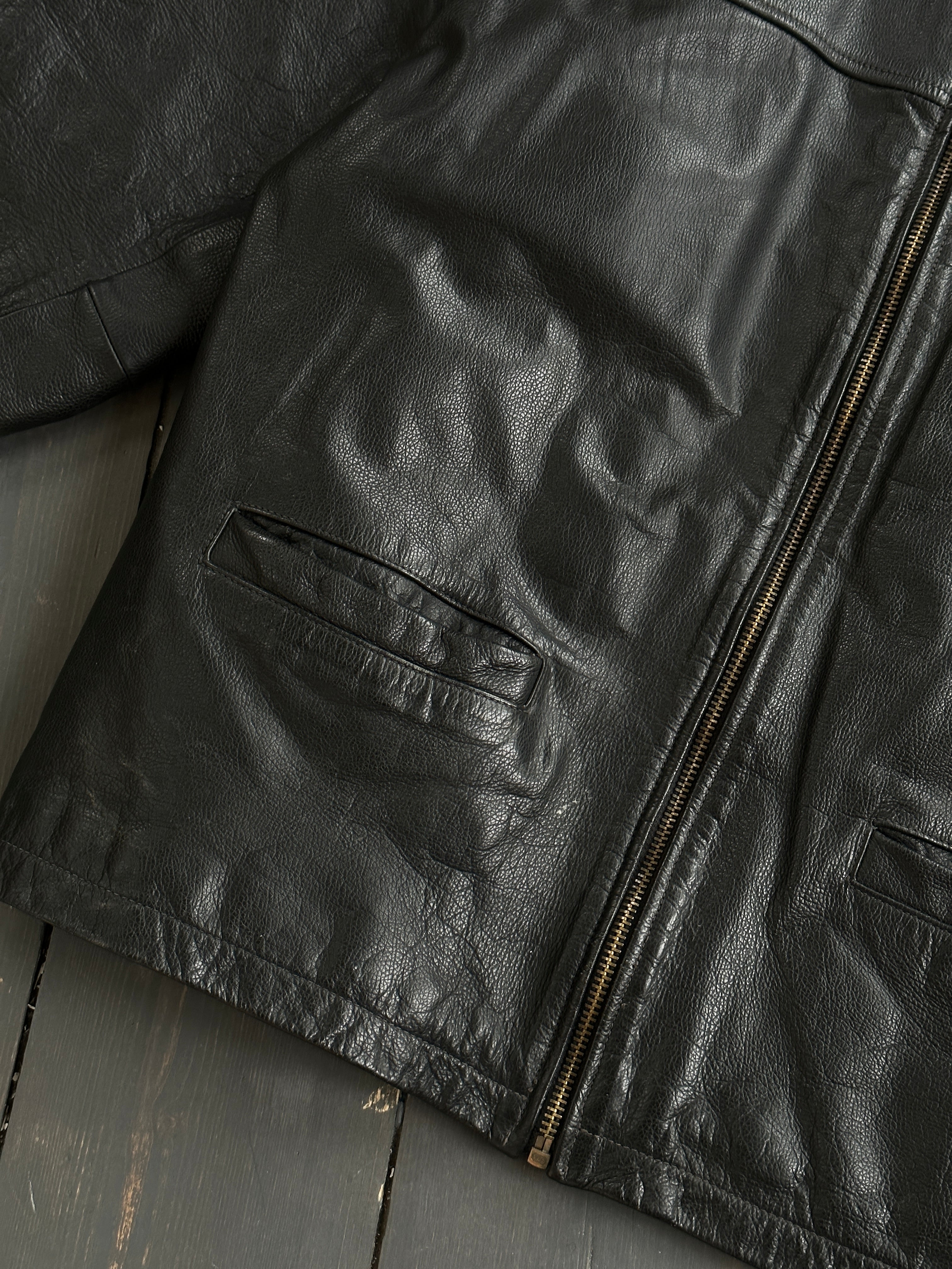 Black vintage boxy leather jacket with classic design and medium fit, featuring a stylish and timeless look.