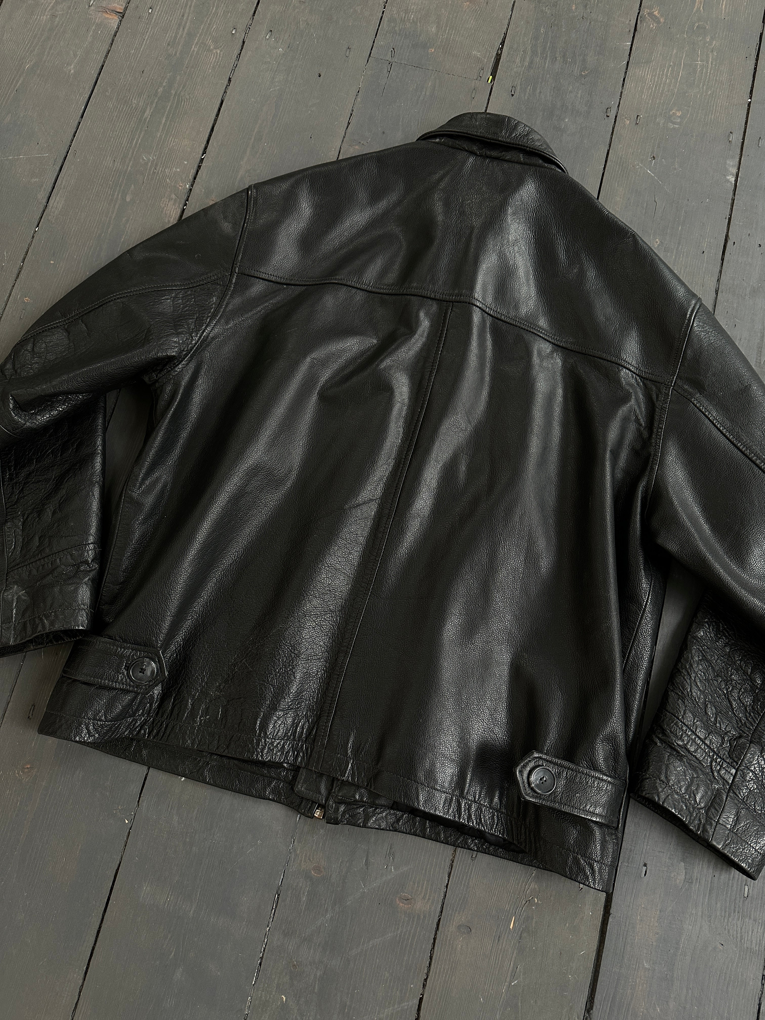 Black vintage boxy leather jacket, medium size, with classic design and textured leather for a stylish, timeless look.