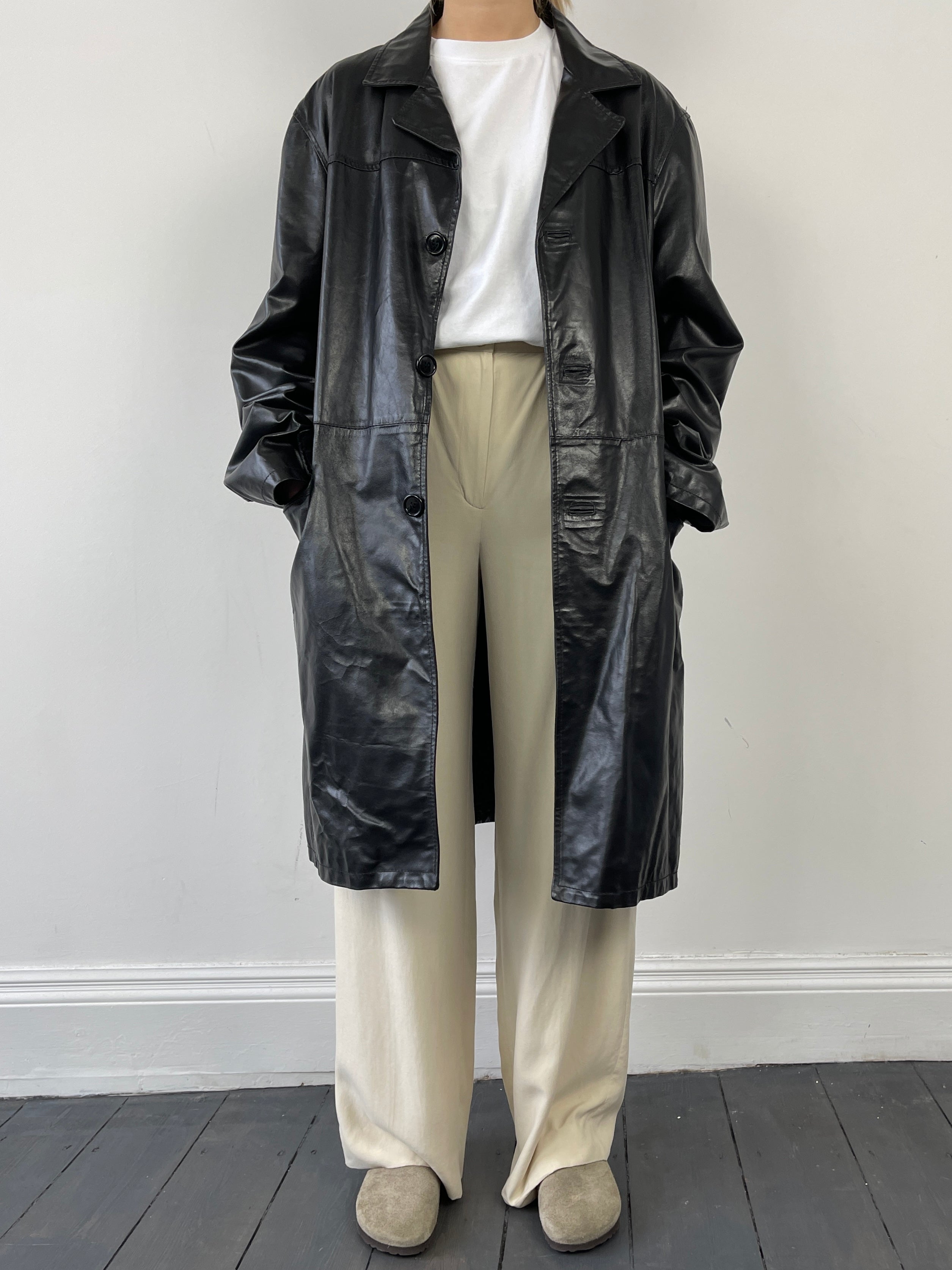 Black Italian vintage leather trench coat jacket with classic design and worn-in look, sized XL and crafted by Vintage brand.