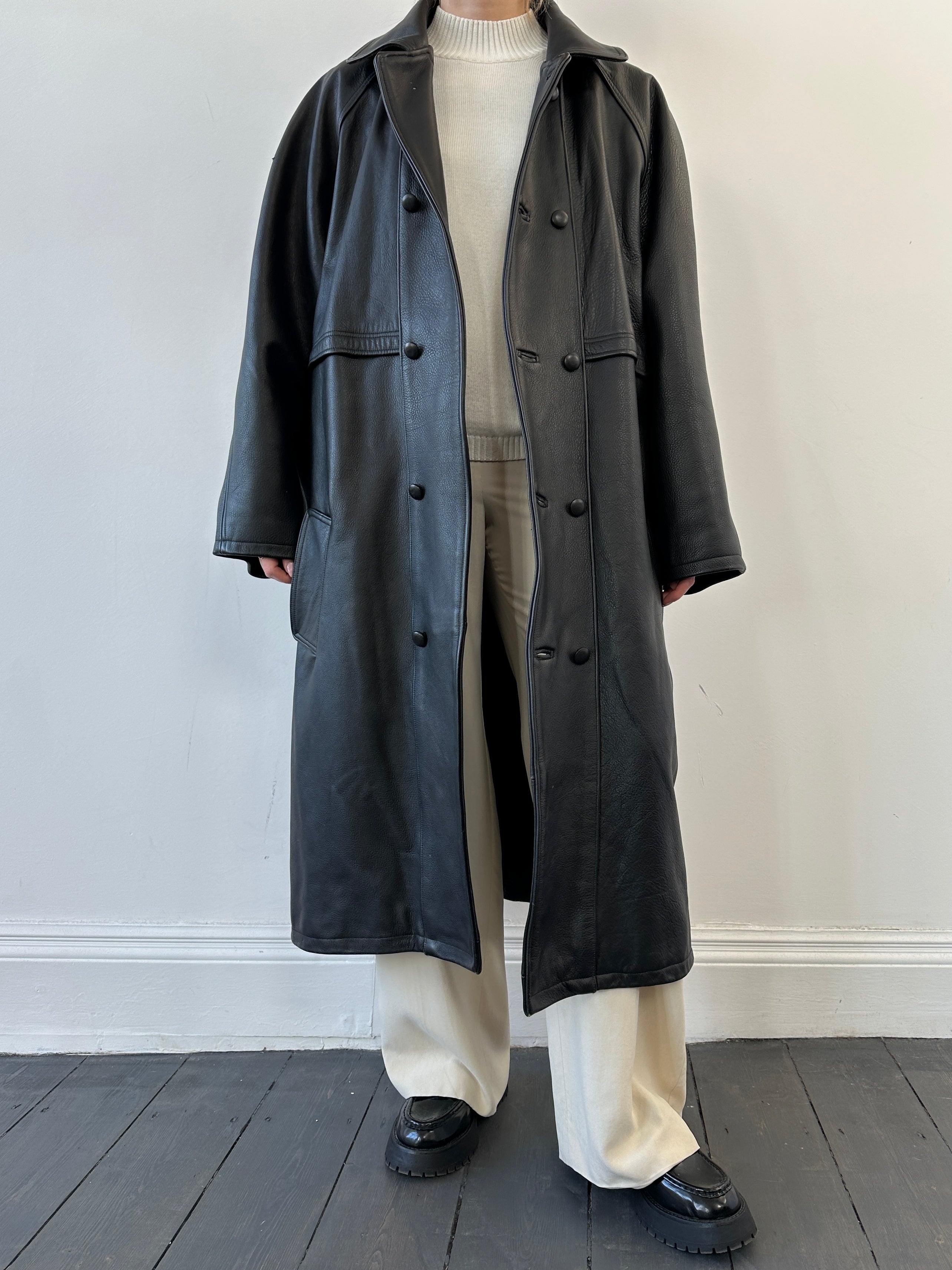 Black vintage leather trench coat jacket with classic design, featuring a tailored fit and stylish collar.