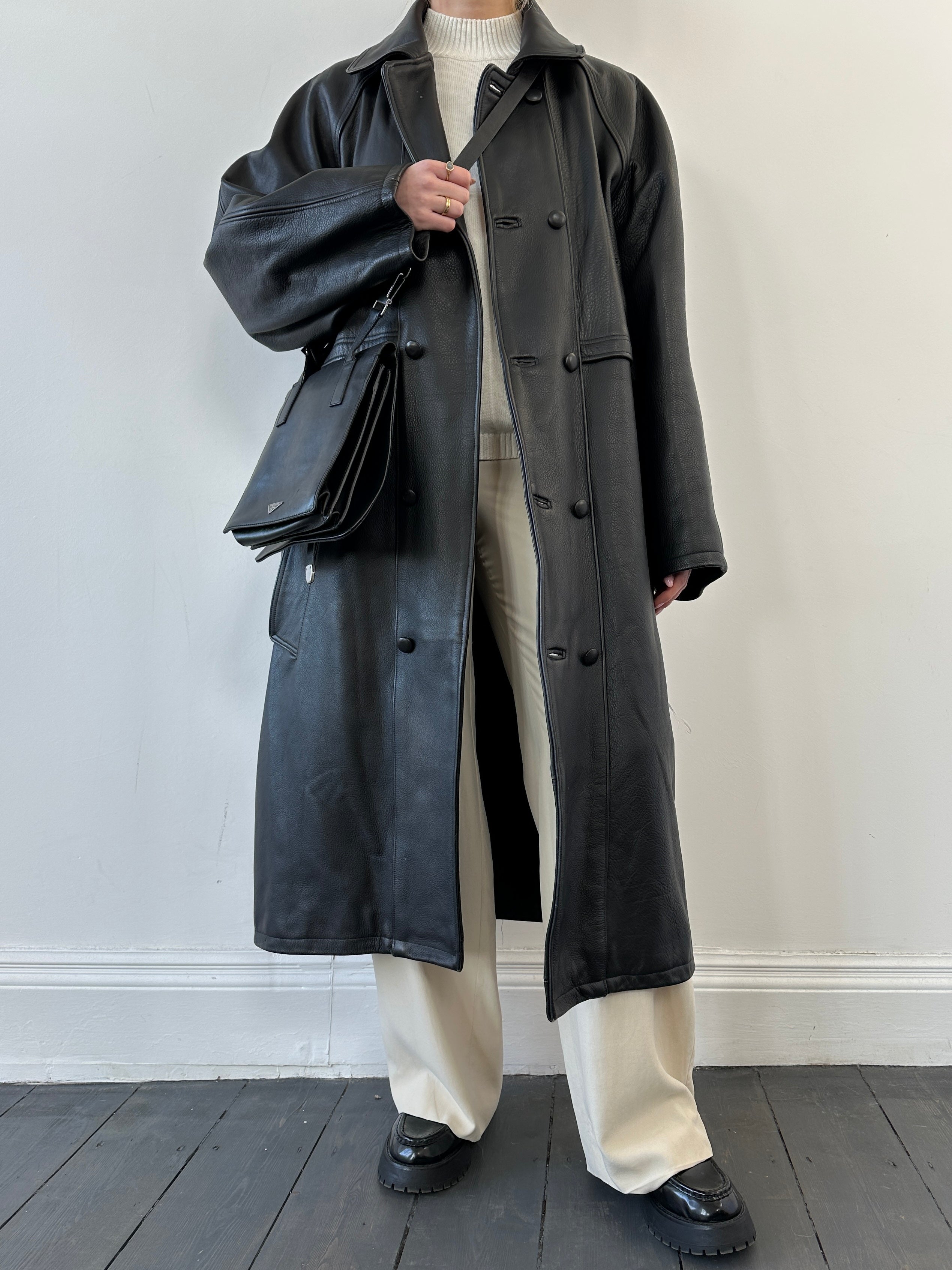 Black vintage leather trench coat jacket with classic design, featuring a tailored fit and stylish collar.