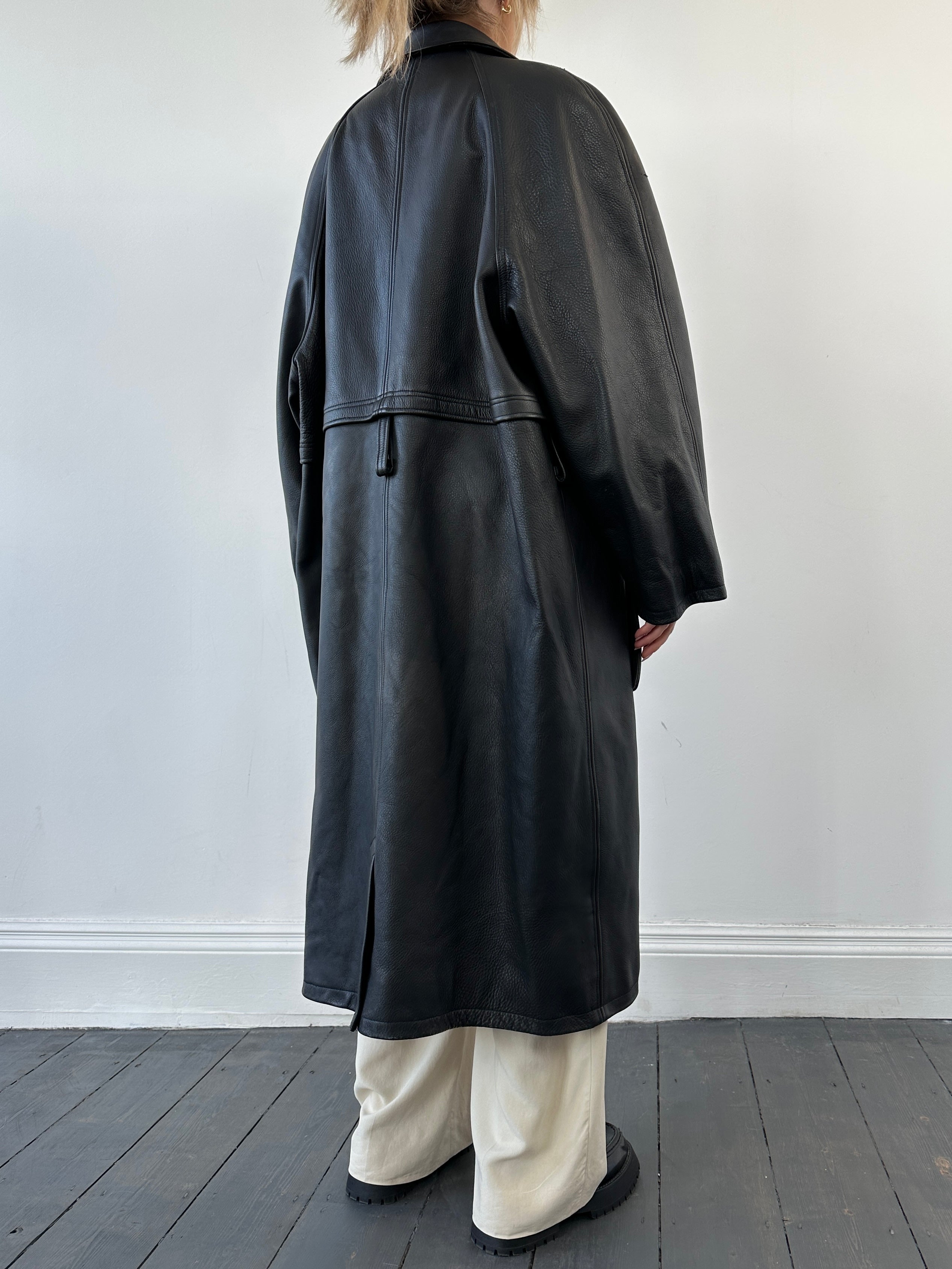 Black vintage leather trench coat jacket with classic design, featuring a tailored fit and stylish details.