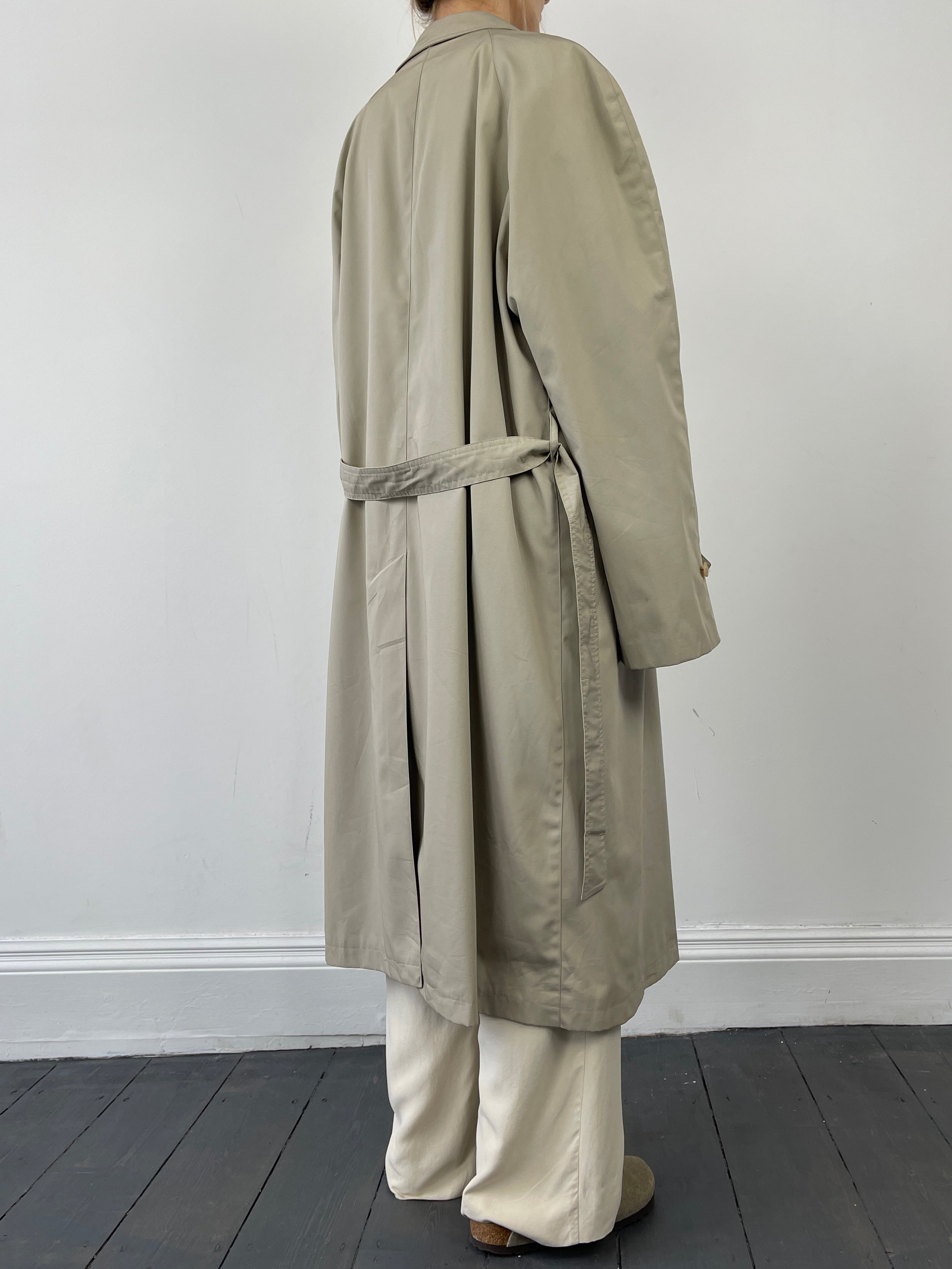 Beige vintage cotton belted trench coat with classic collar and double-breasted design, displayed on a hanger.