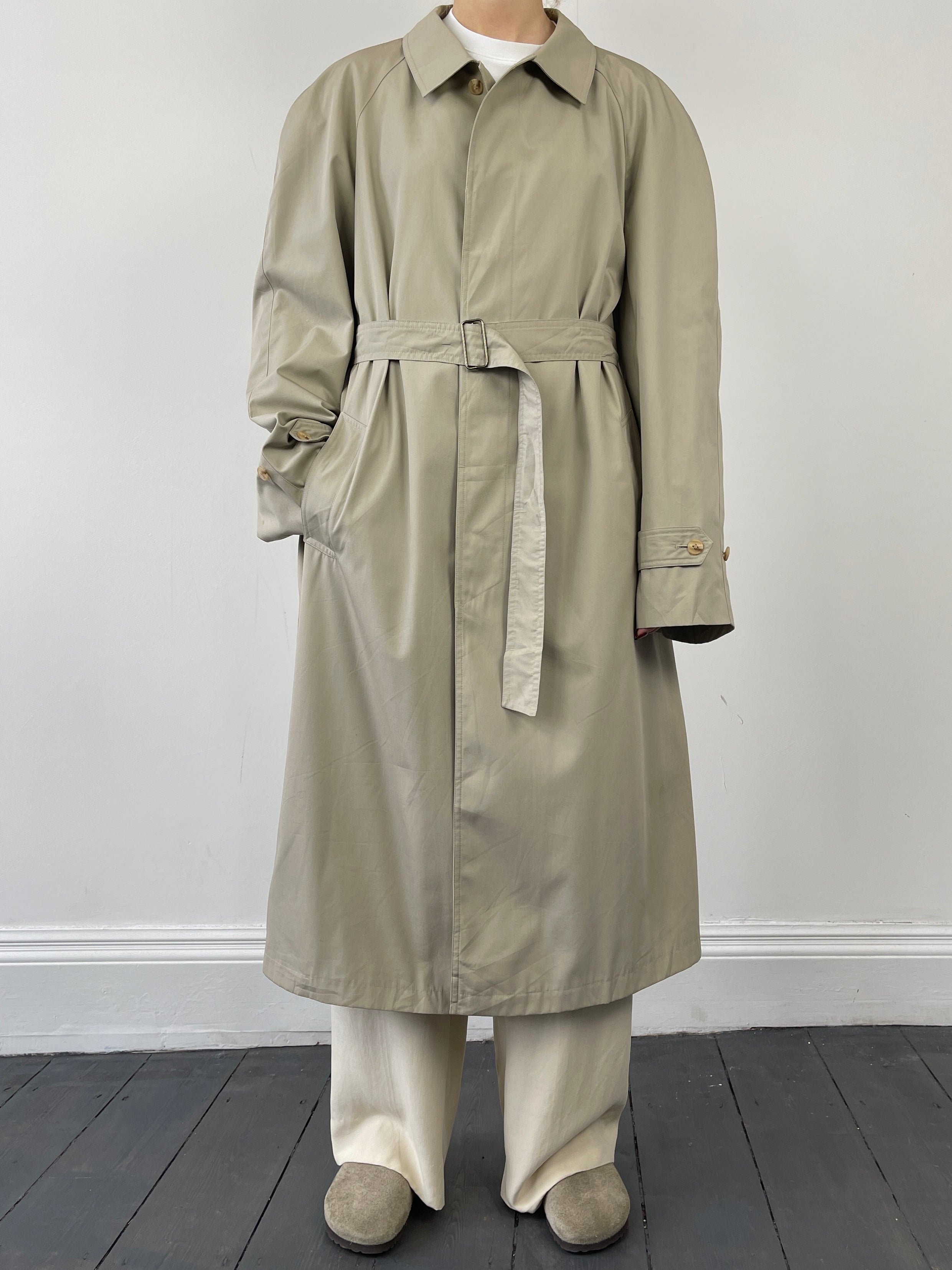 Beige vintage cotton belted trench coat with classic design and large fit, featuring a waist belt for a timeless, stylish look.