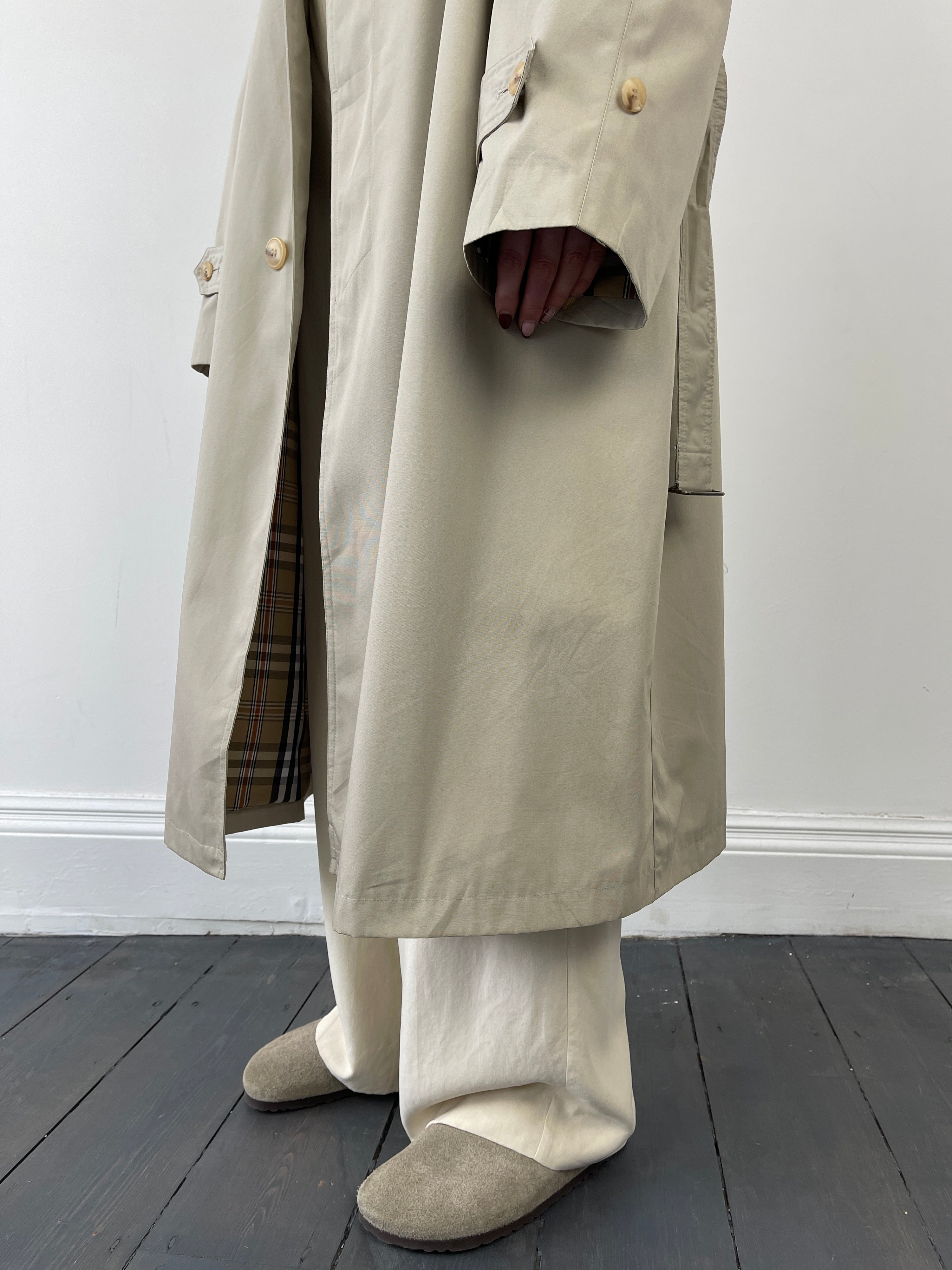 Beige vintage cotton belted trench coat with classic design and large fit, featuring a waist belt and timeless style.