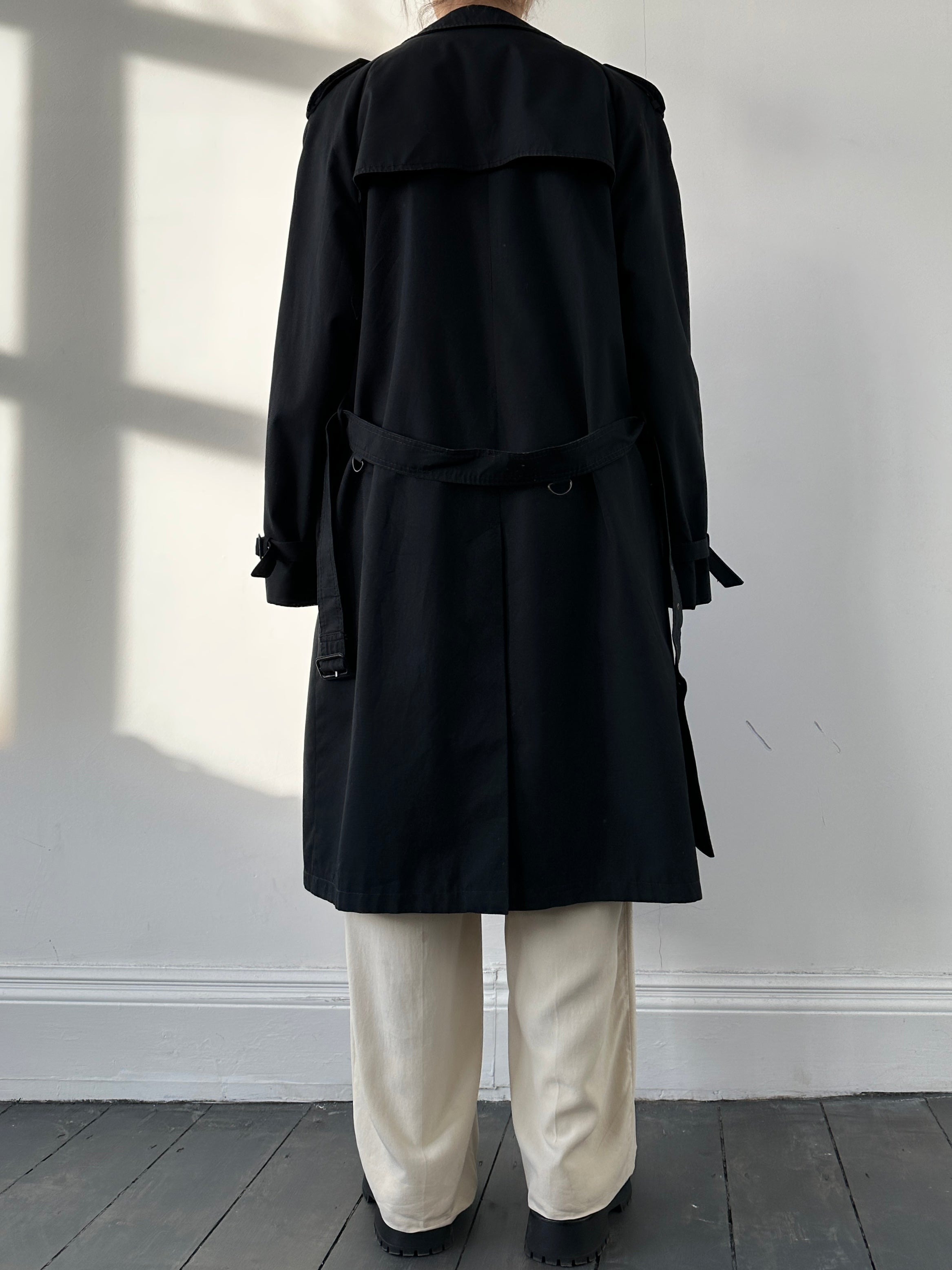 Black vintage belted cotton trench coat with classic design and large fit, featuring a waist belt and traditional trench style.