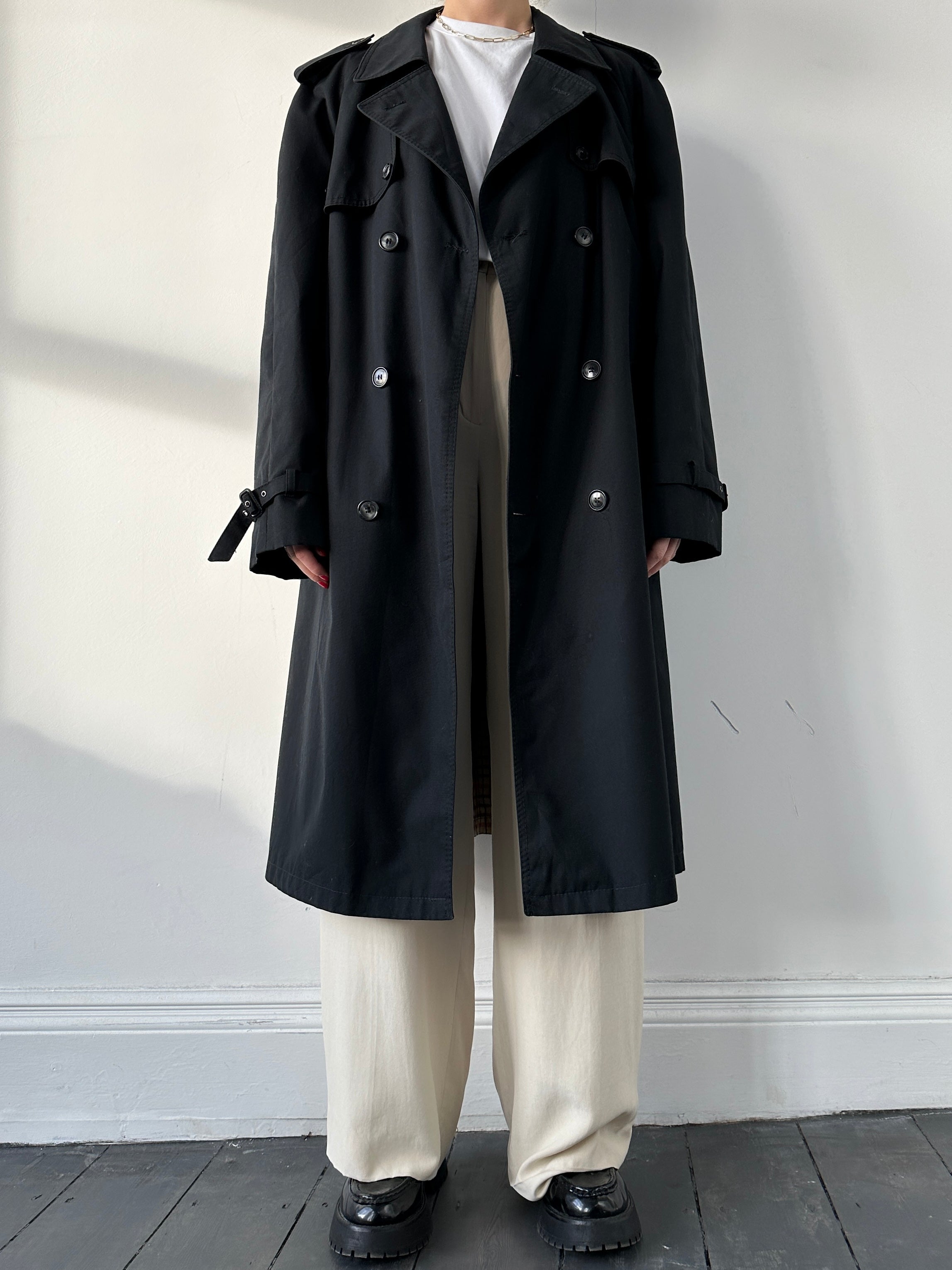 Black vintage belted cotton trench coat with large lapels and classic design, suitable for stylish outerwear.