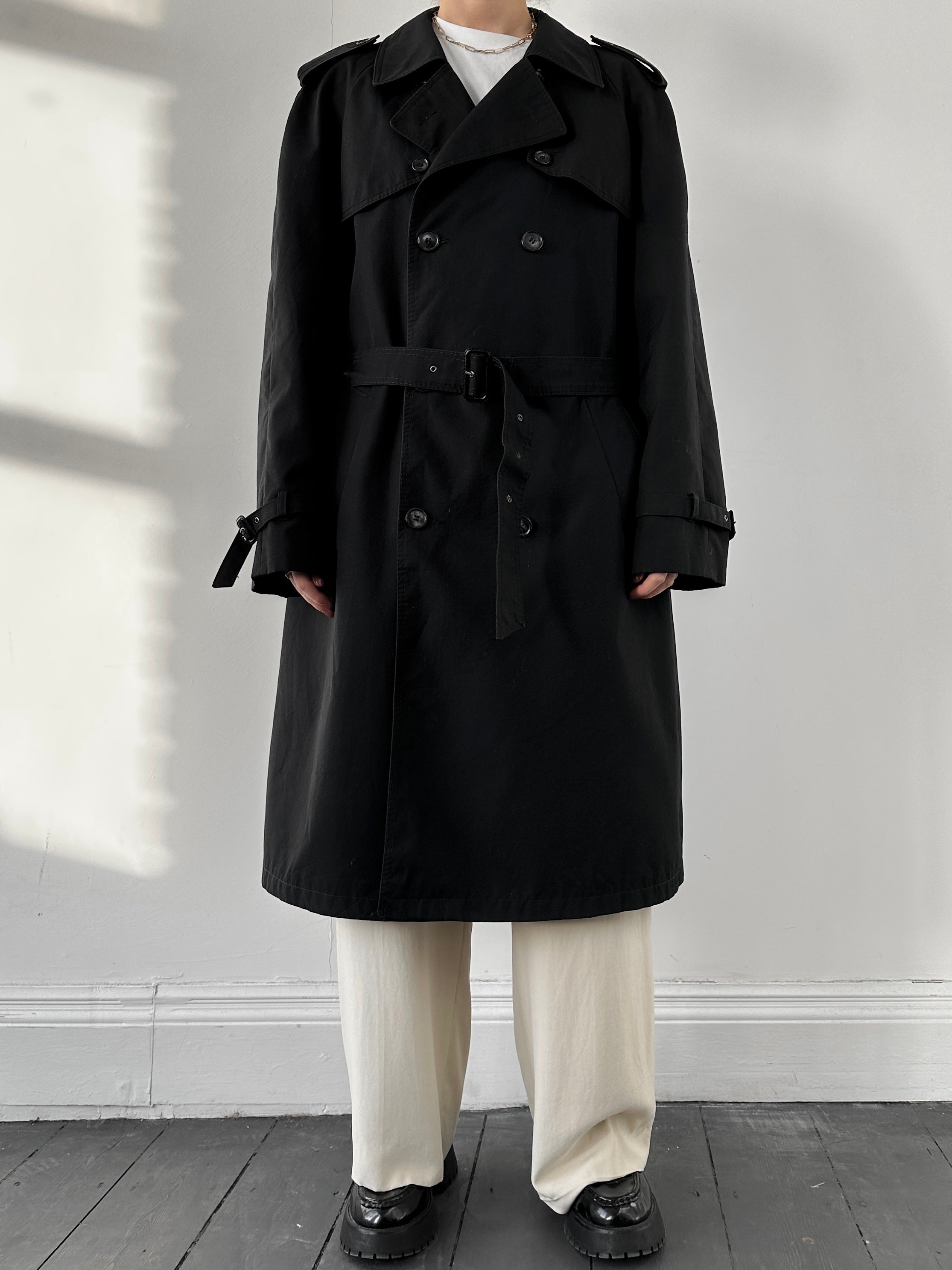 Black vintage belted cotton trench coat with classic design, large fit, and traditional collar, suitable for stylish outerwear.