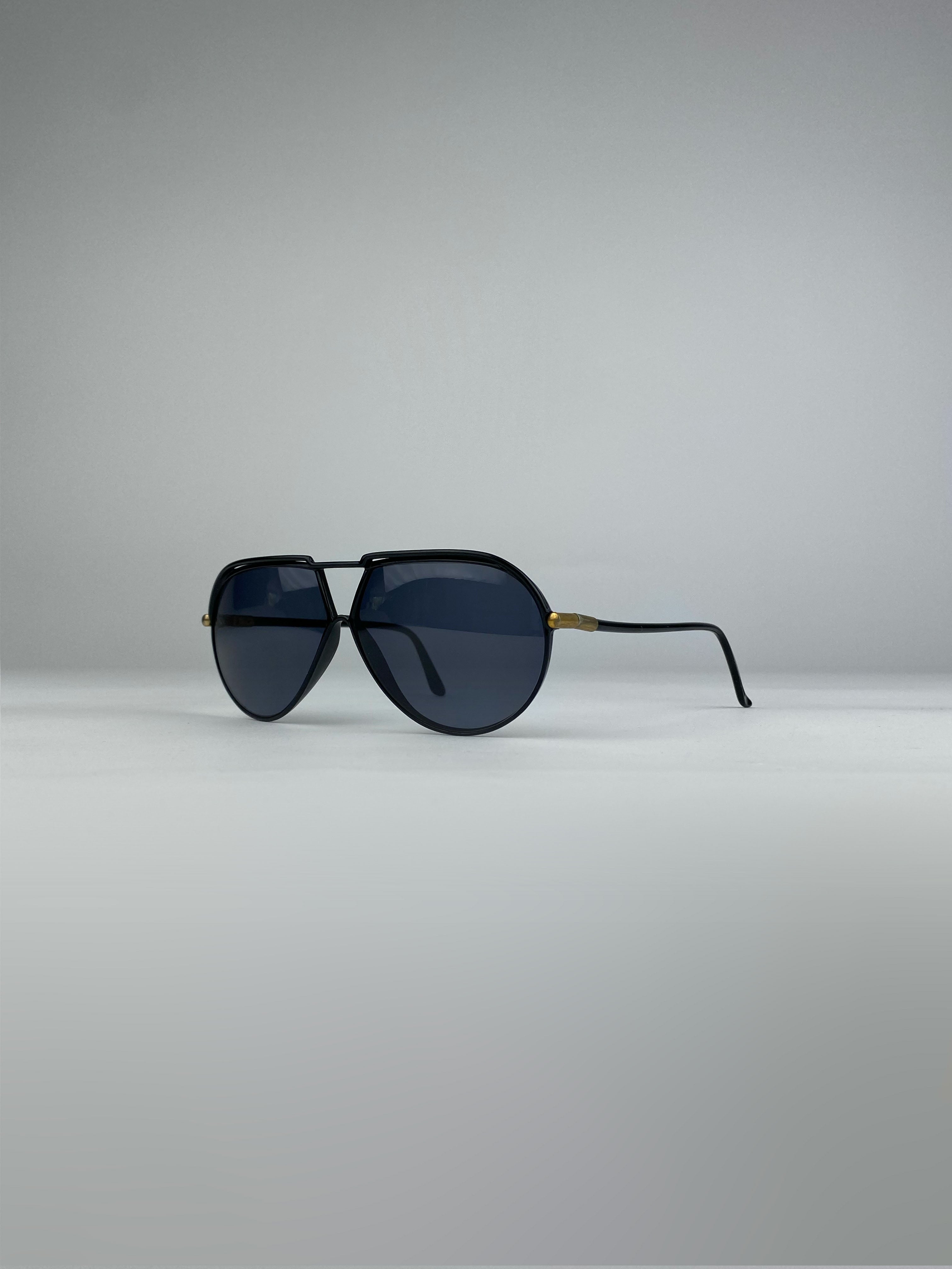 Yves Saint Laurent aviator sunglasses with black frames and tinted lenses, stylish and timeless design.