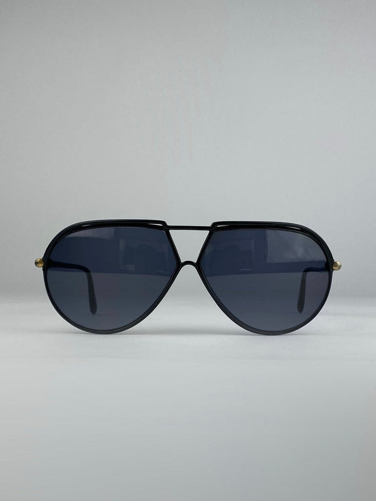 Yves Saint Laurent aviator sunglasses with black frames and dark lenses, stylish and sleek for a modern look.